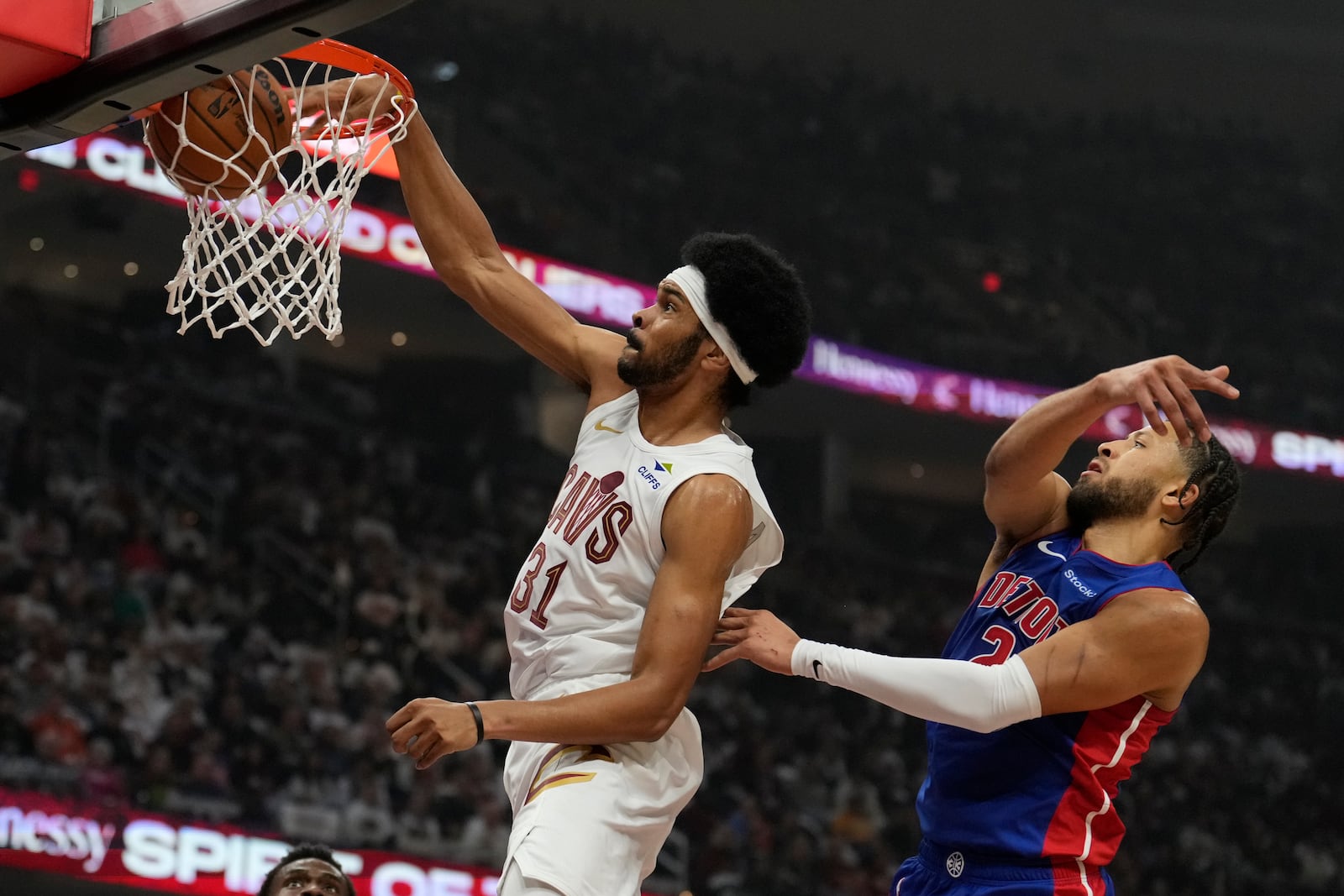 Cleveland Cavaliers center Jarrett Allen (31) dunks in front of Detroit Pistons guard Cade Cunningham (2) in the first half of an NBA basketball game, Friday, Oct. 25, 2024, in Cleveland. (AP Photo/Sue Ogrocki)