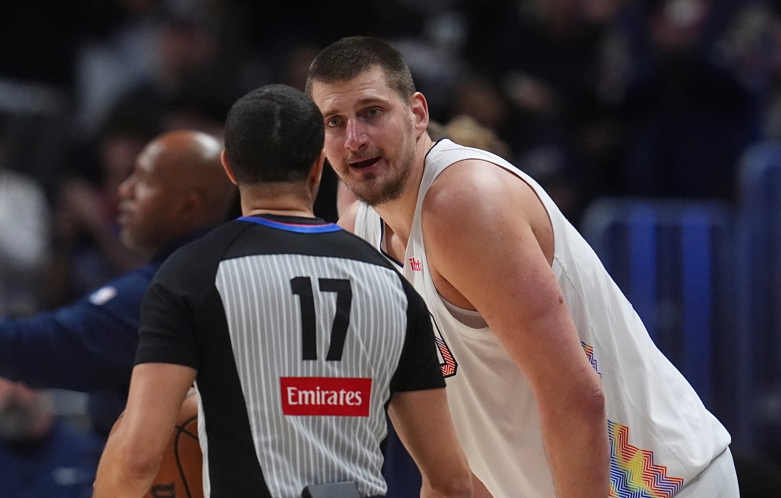 Denver Nuggets center Nikola Jokic, back, argues for a call with referee Jonathan Sterling in the second half of an NBA basketball game against the New Orleans Pelicans Wednesday, Feb. 5, 2025, in Denver. (AP Photo/David Zalubowski)