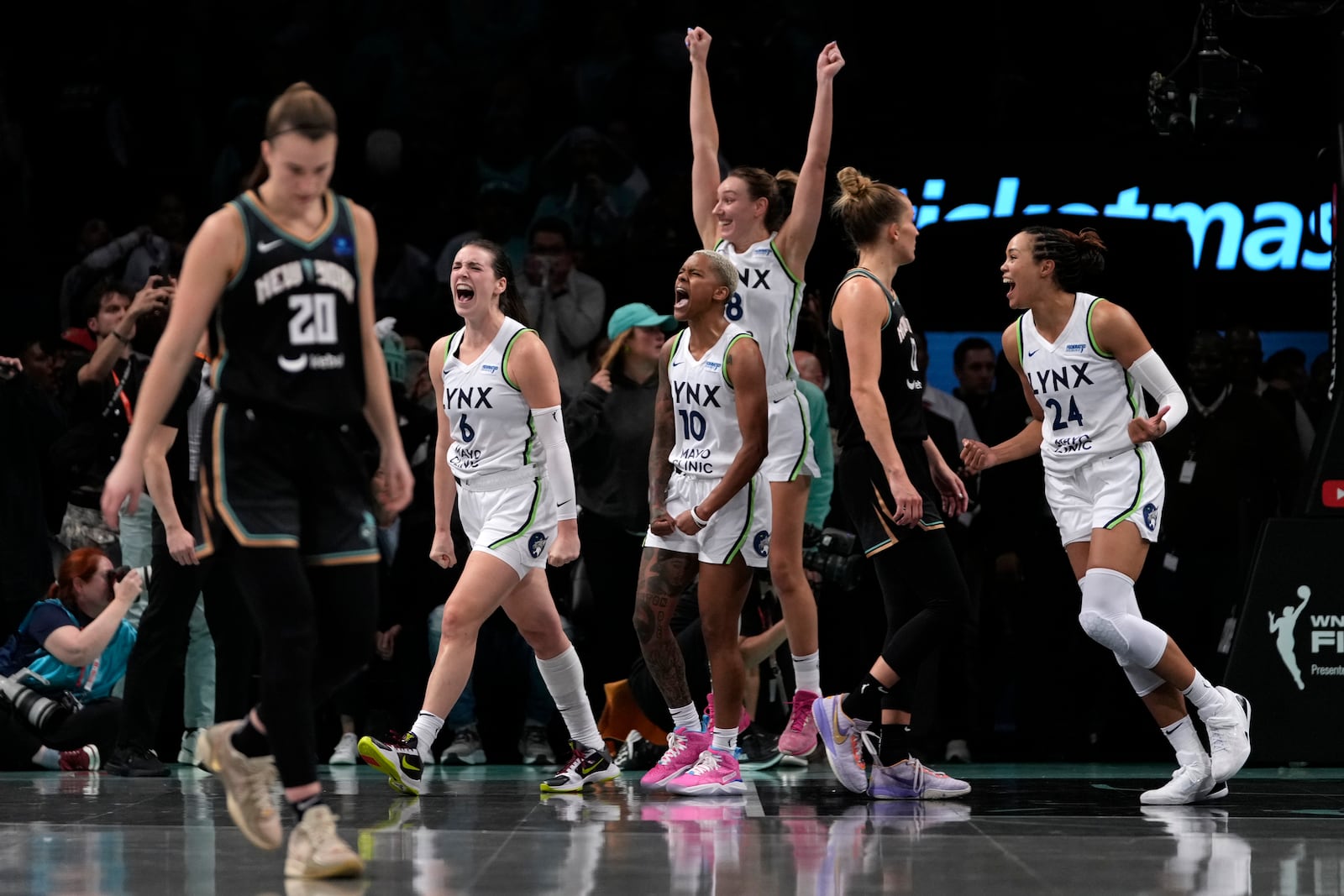 From left, Minnesota Lynx's Bridget Carleton, Courtney Williams, Alanna Smith and Napheesa Collier celebrate after defeating the New York Liberty in overtime in Game 1 of a WNBA basketball final playoff series, Thursday, Oct. 10, 2024, in New York. (AP Photo/Pamela Smith)