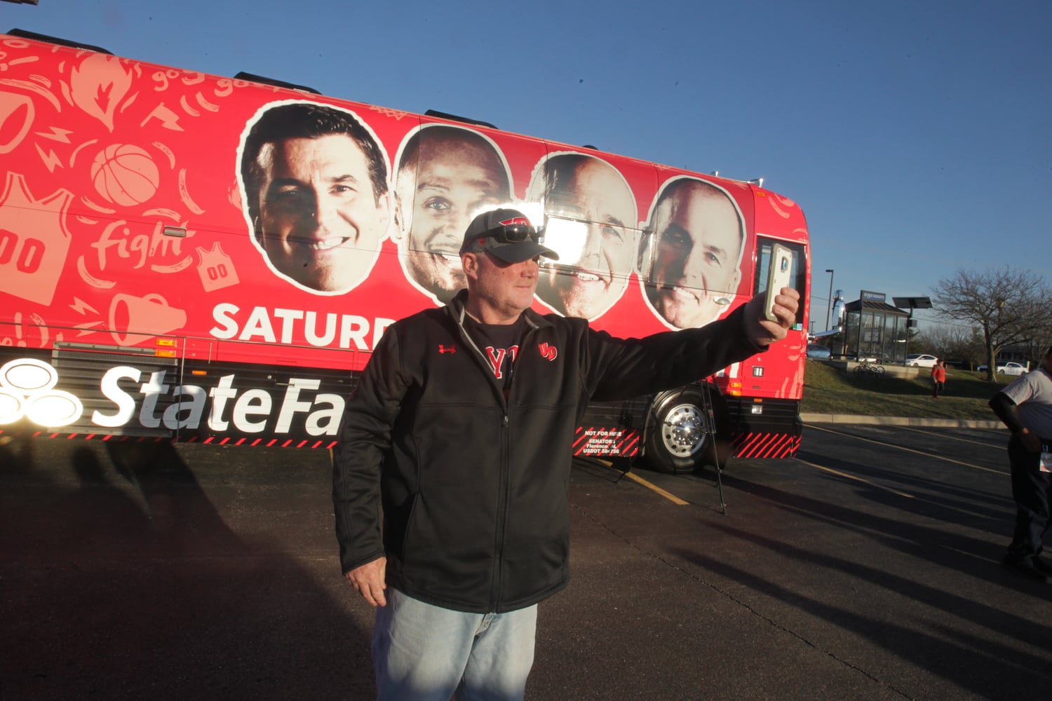 College basketball fans get an early view  of the ESPN College GameDay bus in Huber Heights at the Krogers on Old Troy Pike Thursday.