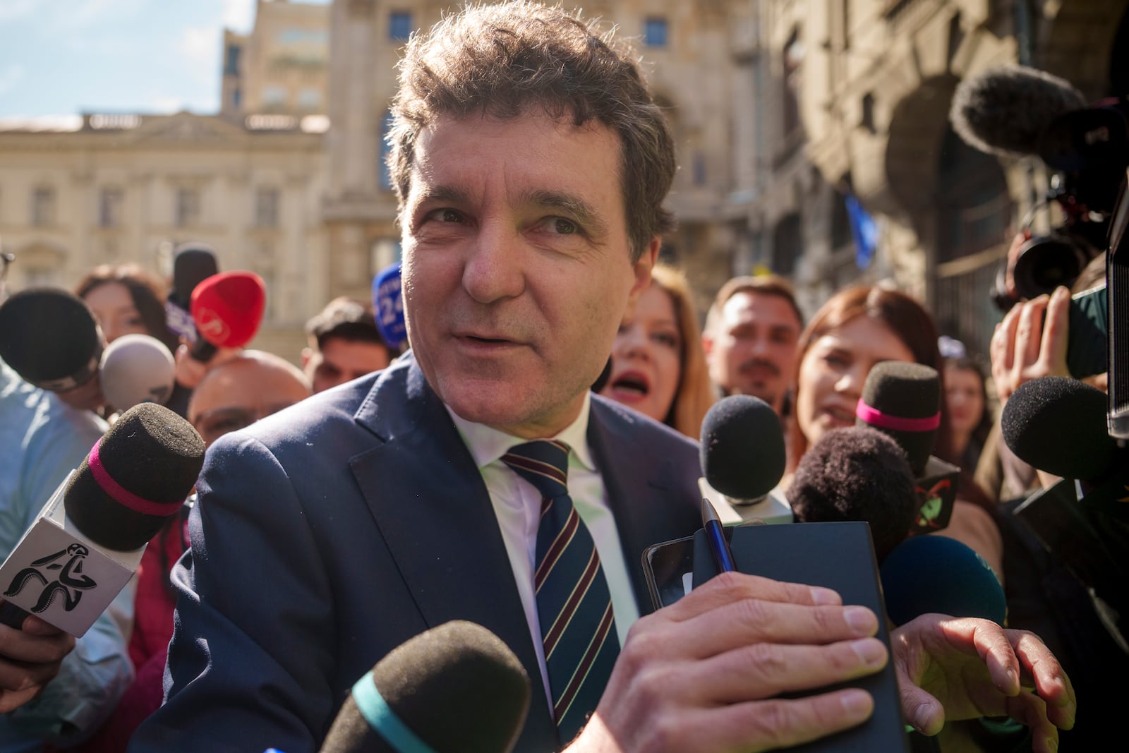 Nicusor Dan, the mayor of Bucharest, speaks to media before registering his bid for the country's presidency, outside Romania's Electoral Authority, in Bucharest, Romania, Friday, March 7, 2025. (AP Photo/Vadim Ghirda)