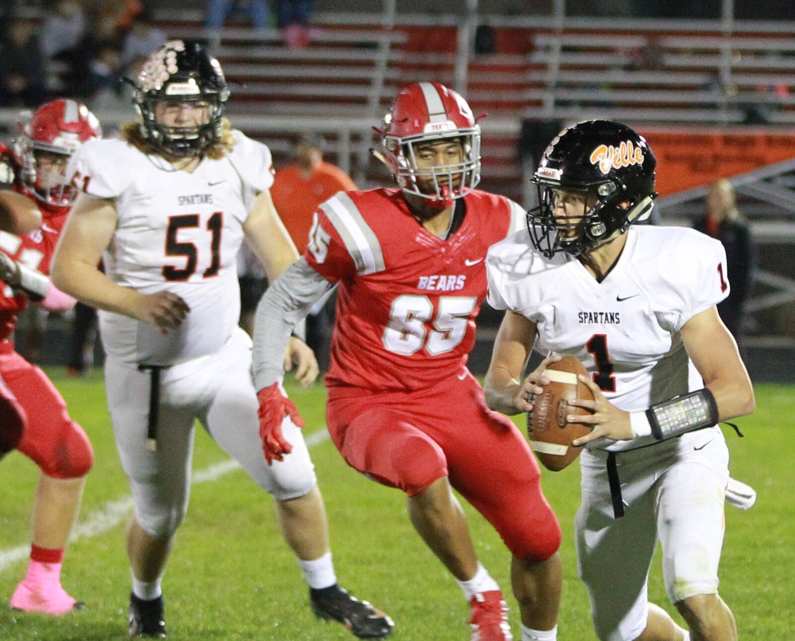 Waynesville QB Jake Amburgy (right) is chased by Cameron Curington of Northridge. Waynesville defeated host Northridge 23-8 in a Week 9 high school football game on Thursday, Oct. 24, 2019. MARC PENDLETON / STAFF