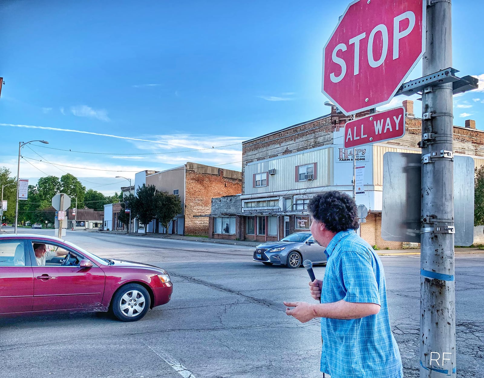 Speyrer on the downtown streets of Mason City near his club, talking to passesby