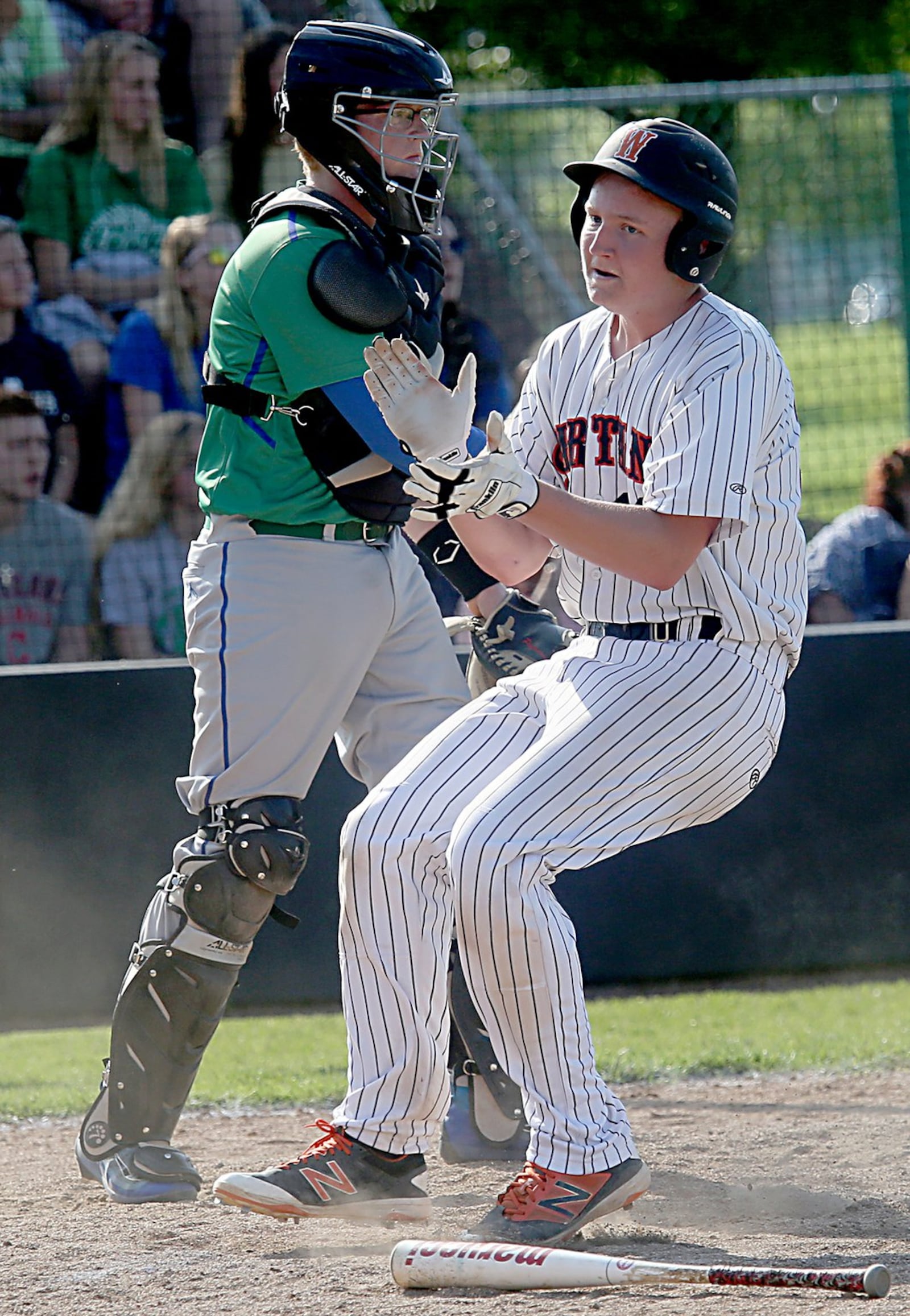 Waynesville’s Tommy Isaacs claps as he crosses home plate in front of Chaminade Julienne catcher Ben Thomas during their Division II regional semifinal at Mason on Friday. CONTRIBUTED PHOTO BY E.L. HUBBARD