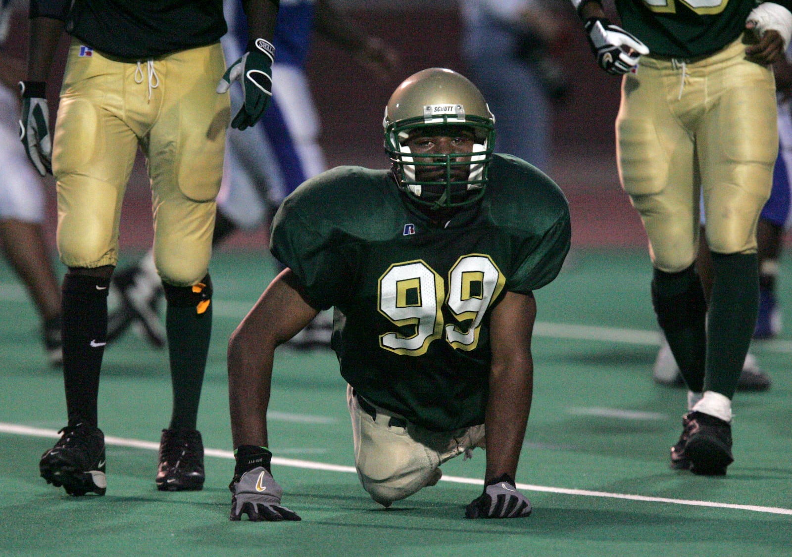 Dayton's Colonel White's Bobby Martin moves off the field after playing on the punt return team vs. Dunbar at Welcome Stadium. Born without legs, Martin makes tackles on two legged players twice his size. Despite being banned from playing on an equipment violation 9no shoes and knee pads) the OHSAA has ruled that he is eligible to take the field again. Photo by Jim Witmer