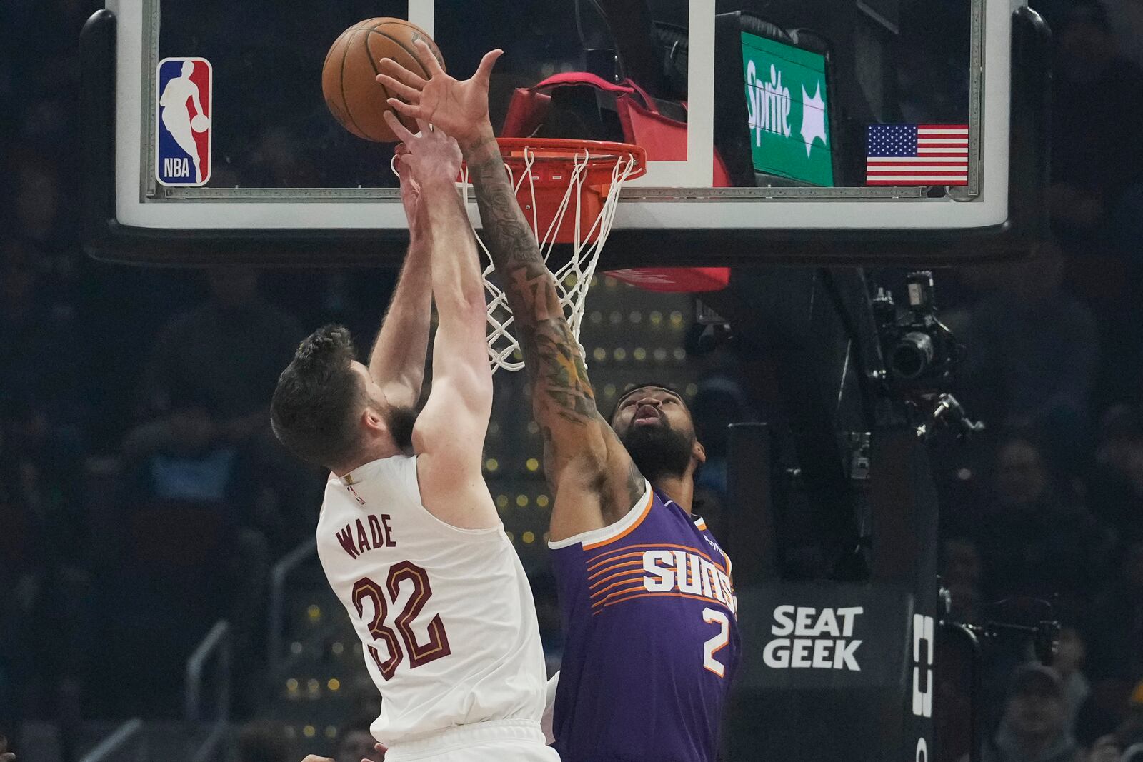 Phoenix Suns center Nick Richards (2) blocks a shot by Cleveland Cavaliers forward Dean Wade (32) in the first half of an NBA basketball game, Monday, Jan. 20, 2025, in Cleveland. (AP Photo/Sue Ogrocki)