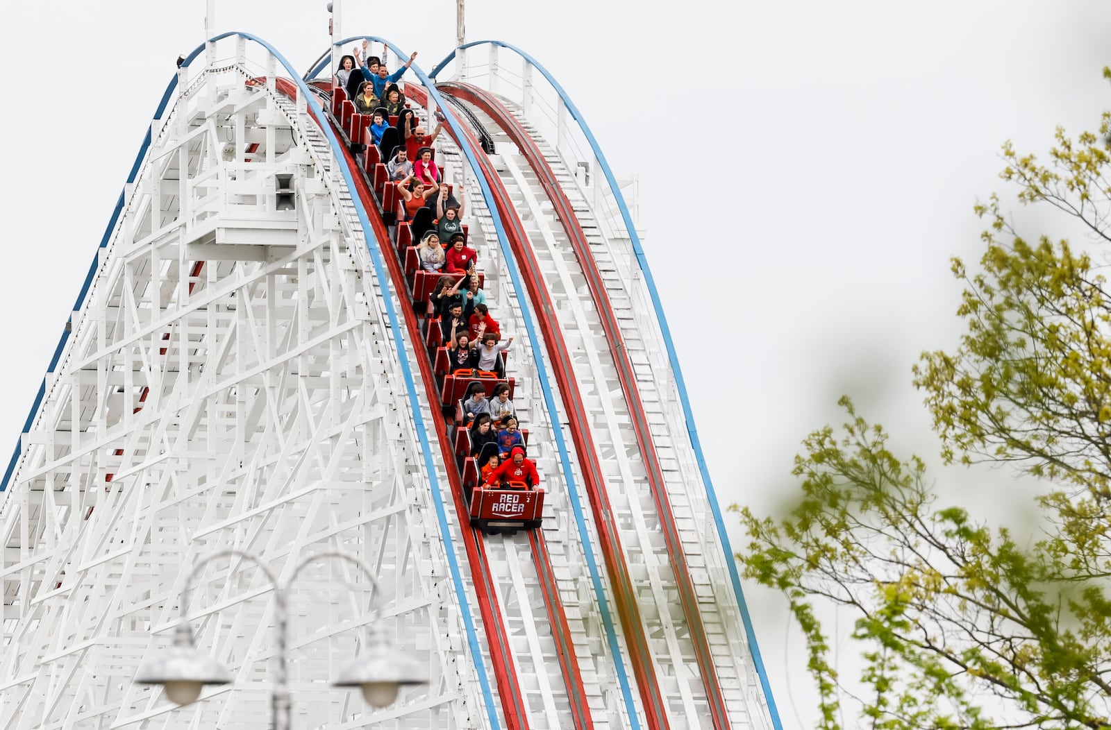 Visitors ride The Racer after Kings Island held an opening ceremony and ribbon cutting Friday, April 29, 2022 in celebration of their 50th Anniversary. NICK GRAHAM/STAFF