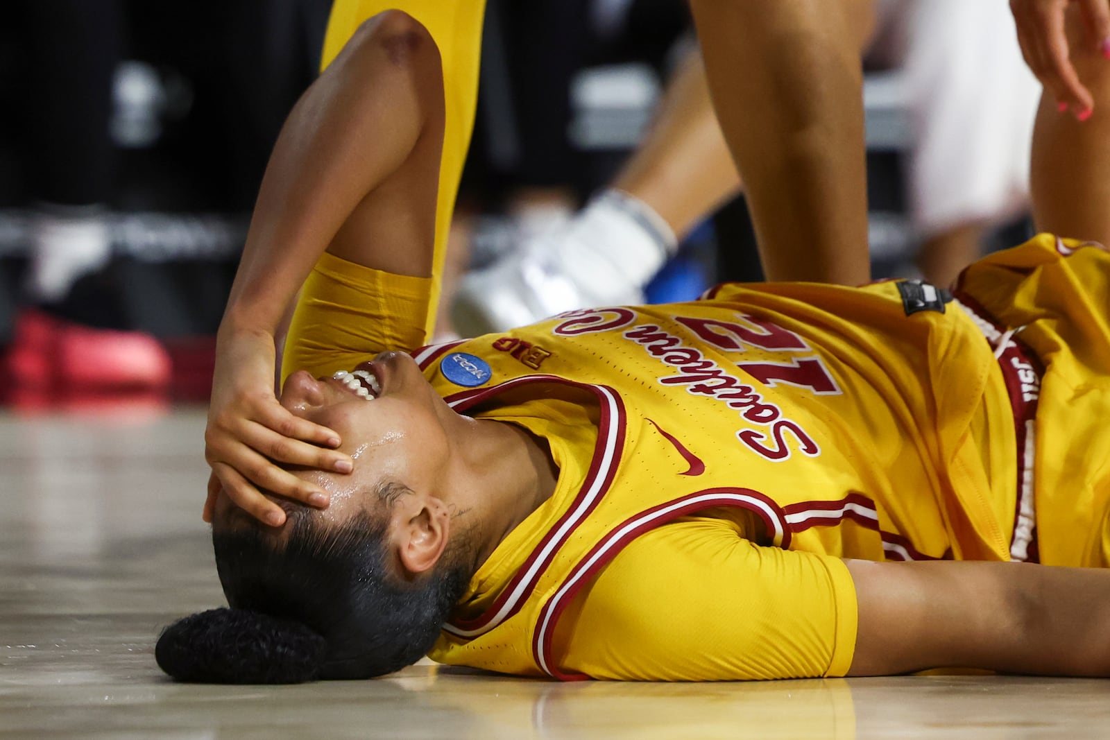 Southern California guard JuJu Watkins (12) reacts on the floor after an injury during the first half against Mississippi State in the second round of the NCAA college basketball tournament Monday, March 24, 2025, in Los Angeles. (AP Photo/Jessie Alcheh)