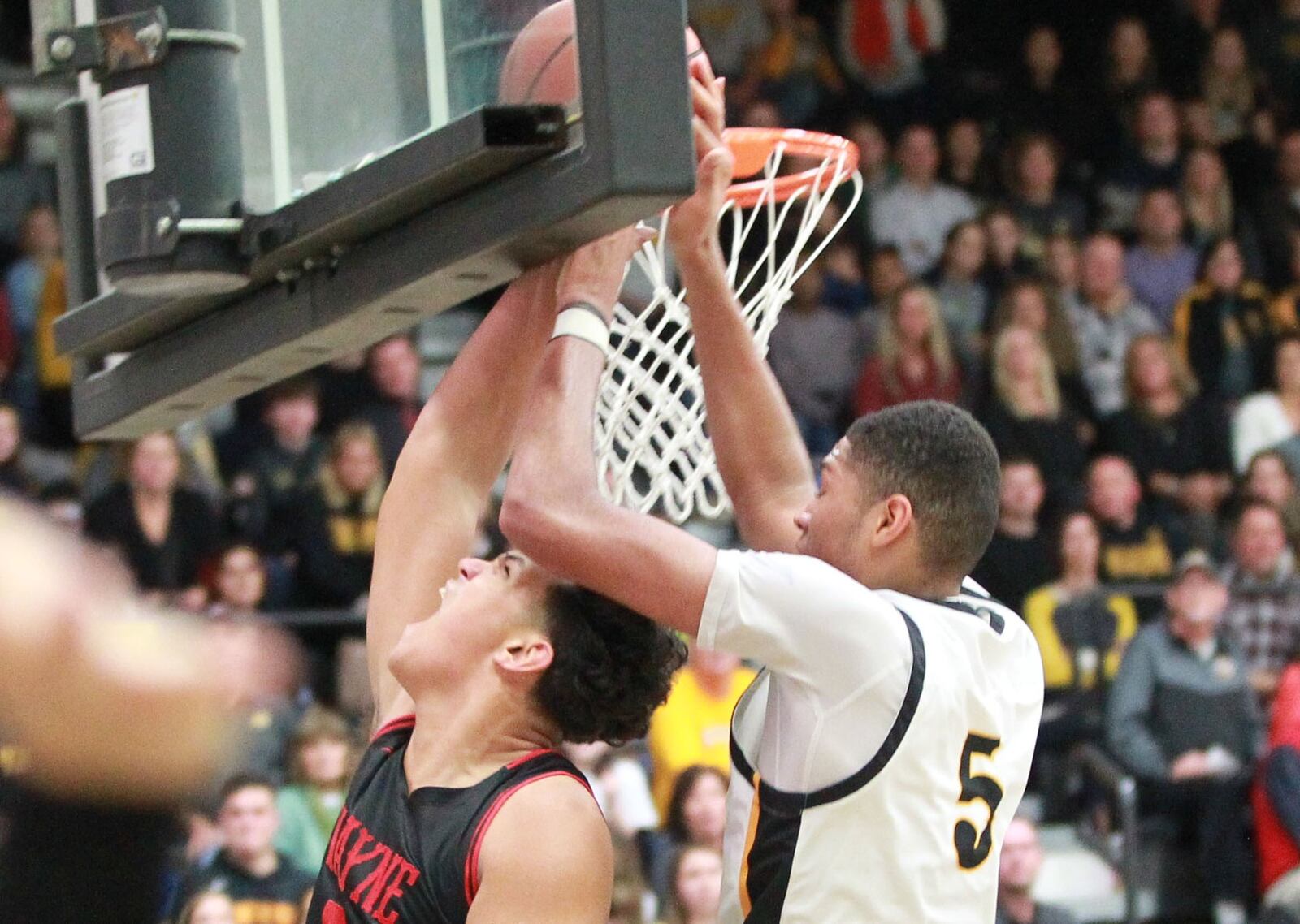 Mo Njie of Centerville (right) blocks a shot by Elijah Brown of Wayne. Wayne defeated host Centerville 52-50 in a GWOC boys high school basketball game on Friday, Dec. 13, 2019. MARC PENDLETON / STAFF