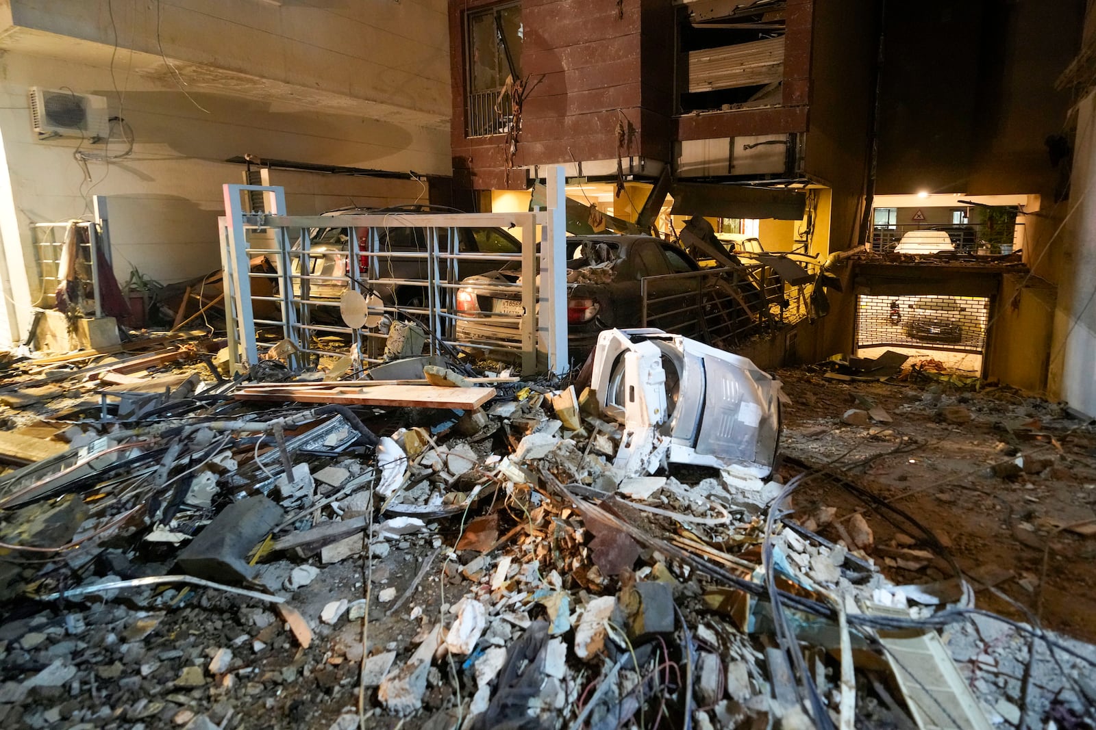 Damage litters the site of an Israeli airstrike in Beirut, Lebanon, Thursday, Oct. 10, 2024. (AP Photo/Hassan Ammar)