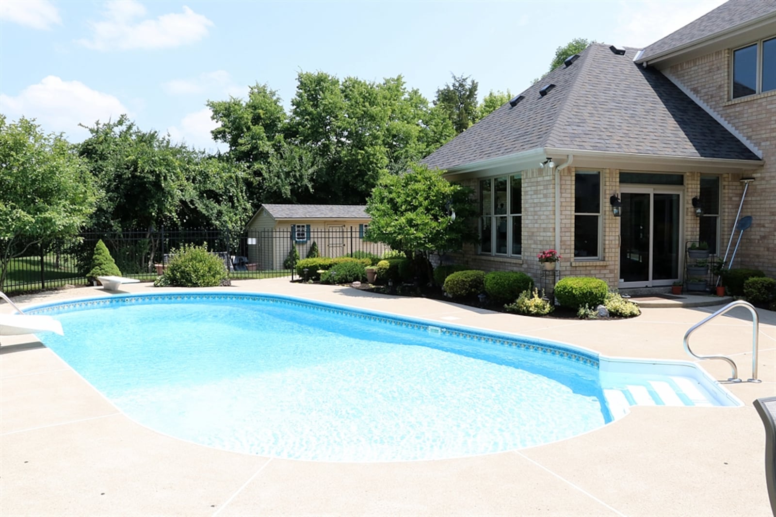 The 1.12-acre property includes a garden barn, four-car garage and an in-ground swimming pool.