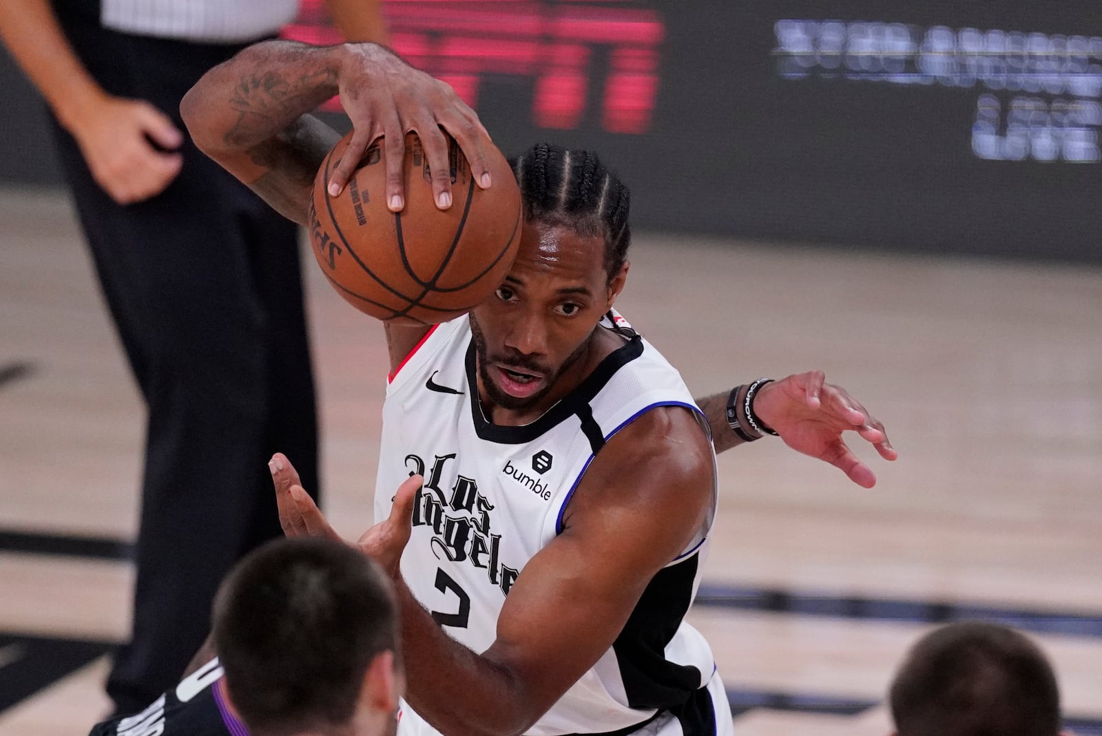 Los Angeles Clippers' Kawhi Leonard (2) grabs a loose ball during the first half of an NBA conference semifinal playoff basketball game against the Denver Nuggets, Wednesday, Sept. 9, 2020, in Lake Buena Vista, Fla. (AP Photo/Mark J. Terrill)