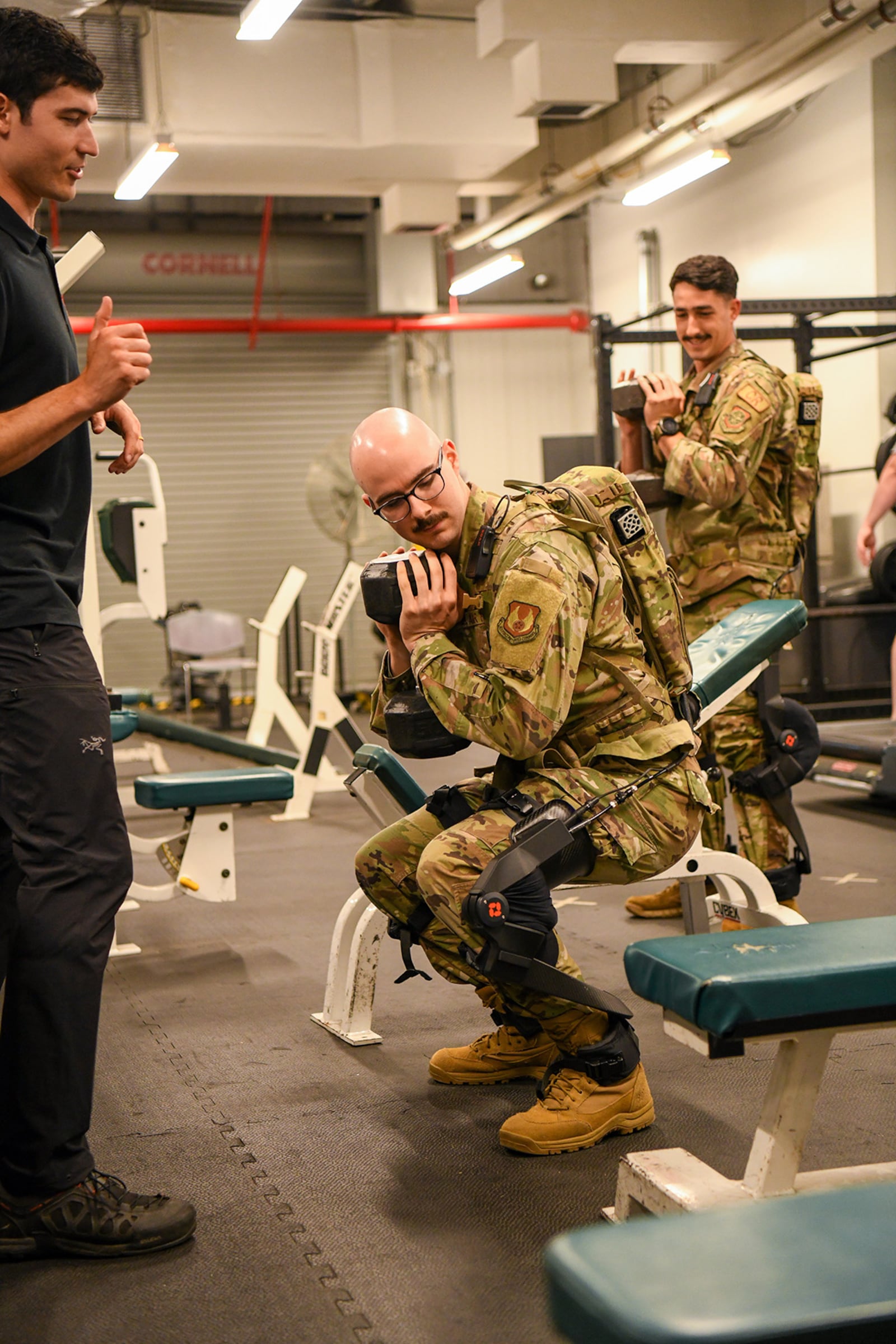 2nd Lt. Ian Casciola, special warfare electrical engineer with the 711th Human Performance Wing in AFRL, performs a squat while wearing a pneumatically powered exoskeleton system, developed by ROAM Robotics, during an AFRL demonstration Oct. 6 at the 445th Airlift Wing, Wright-Patterson Air Force Base, Ohio. (U.S. Air Force photo / Patrick O’Reilly)