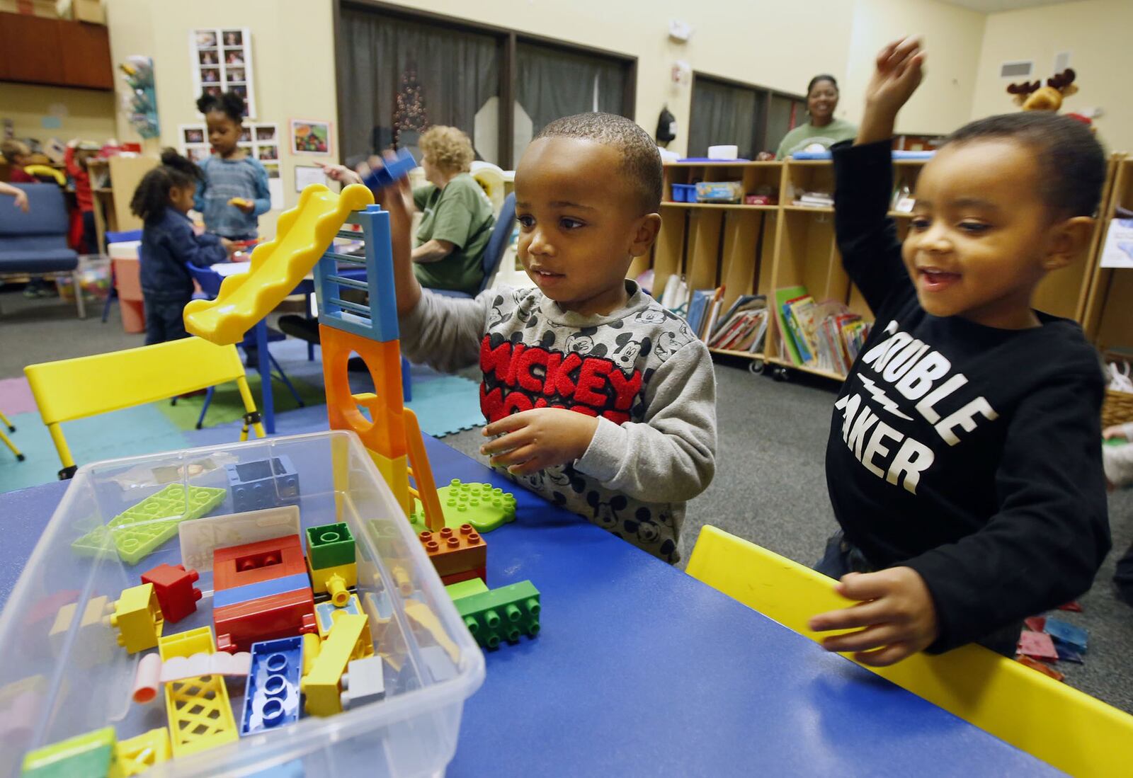 Good Shepherd Academy center students Caleb Jones, left, and Aiden Young built a slide for blocks within the Jubilee Community Church in Springboro. TY GREENLEES / STAFF