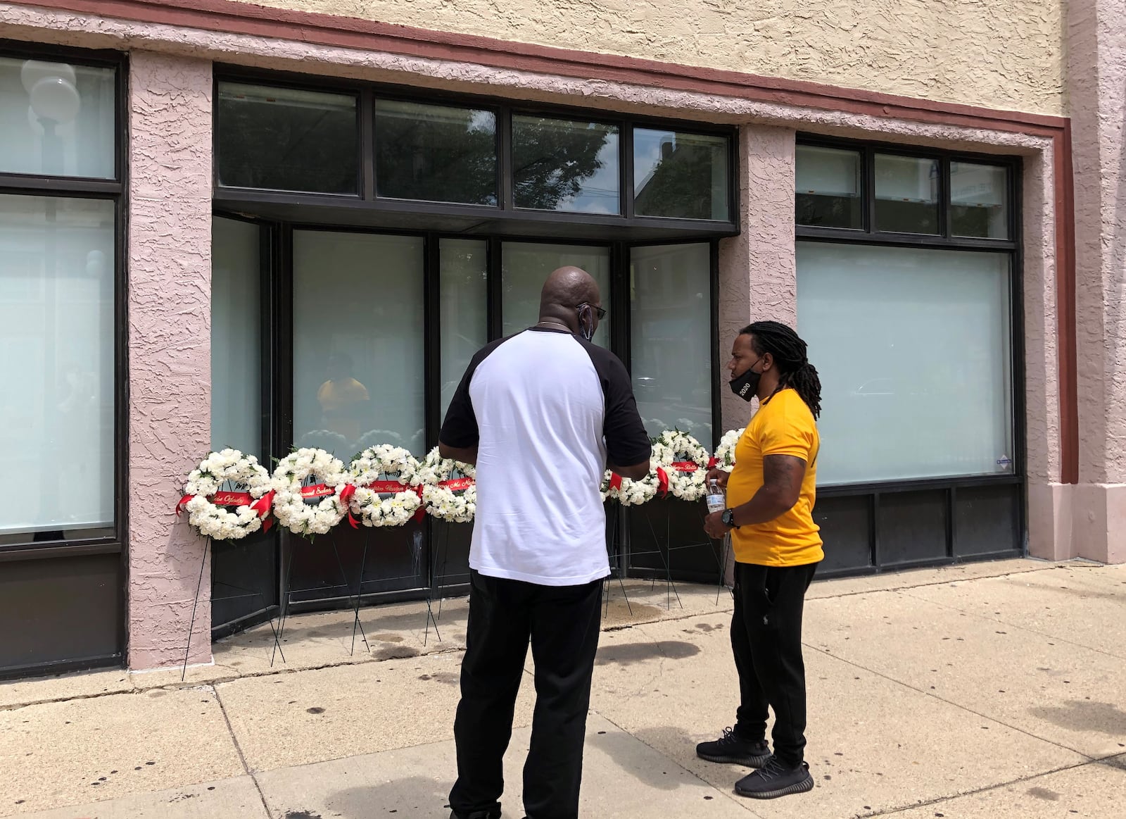 Dion Green and Thomas McNichols talk in the Oregon District on Tuesday, Aug. 4, 2020. McNichols lost his son and Green lost his father on this day one year ago when a shooter opened fire in the entertainment district. STAFF/BONNIE MEIBERS