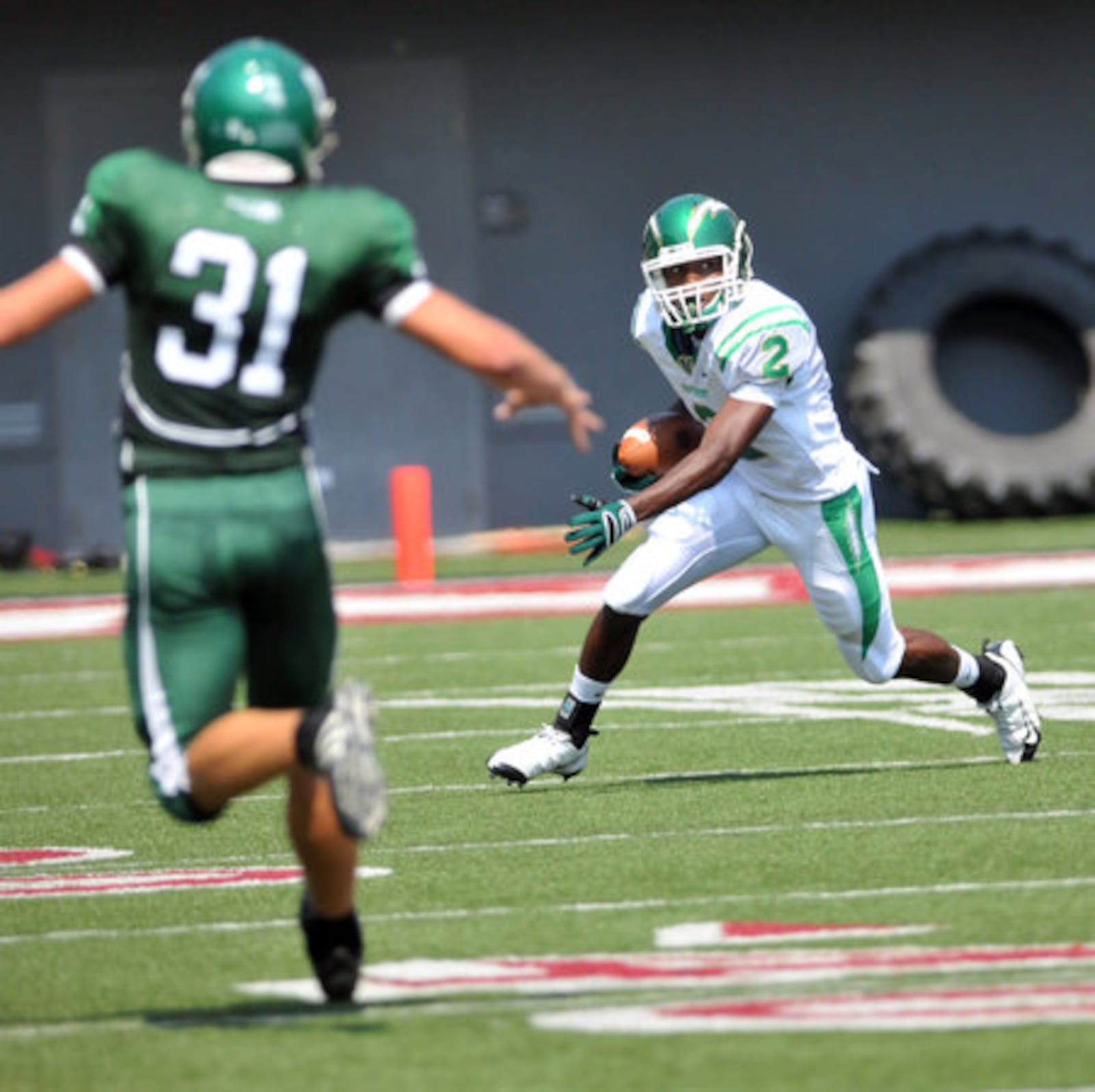 Northmont's C.J. Barnett runs the ball during their Crosstown Showdown game against Mason at Nippert Stadium at the University of Cincinnati on Saturday.