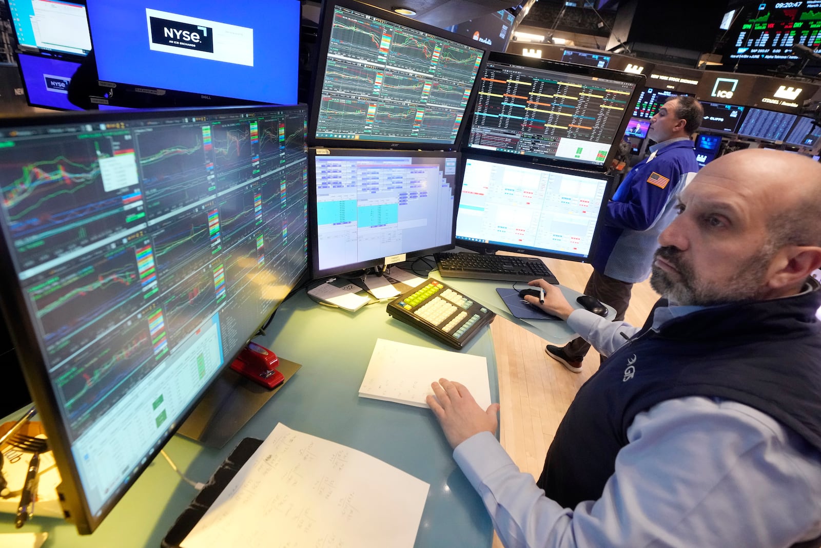 Specialist James Denaro works on the floor of the New York Stock Exchange, Wednesday, March 12, 2025. (AP Photo/Richard Drew)