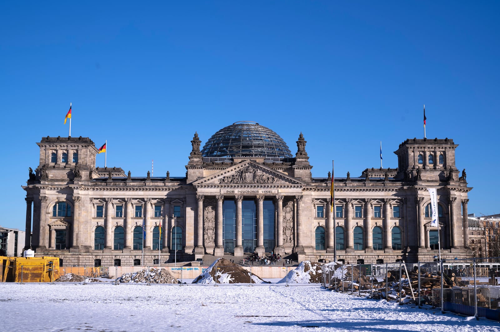 Snow covers the ground in front of the Reichstag building, home of the German parliament Bundestag in Berlin, Germany, Wednesday, Feb. 19, 2025. (AP Photo/Markus Schreiber)