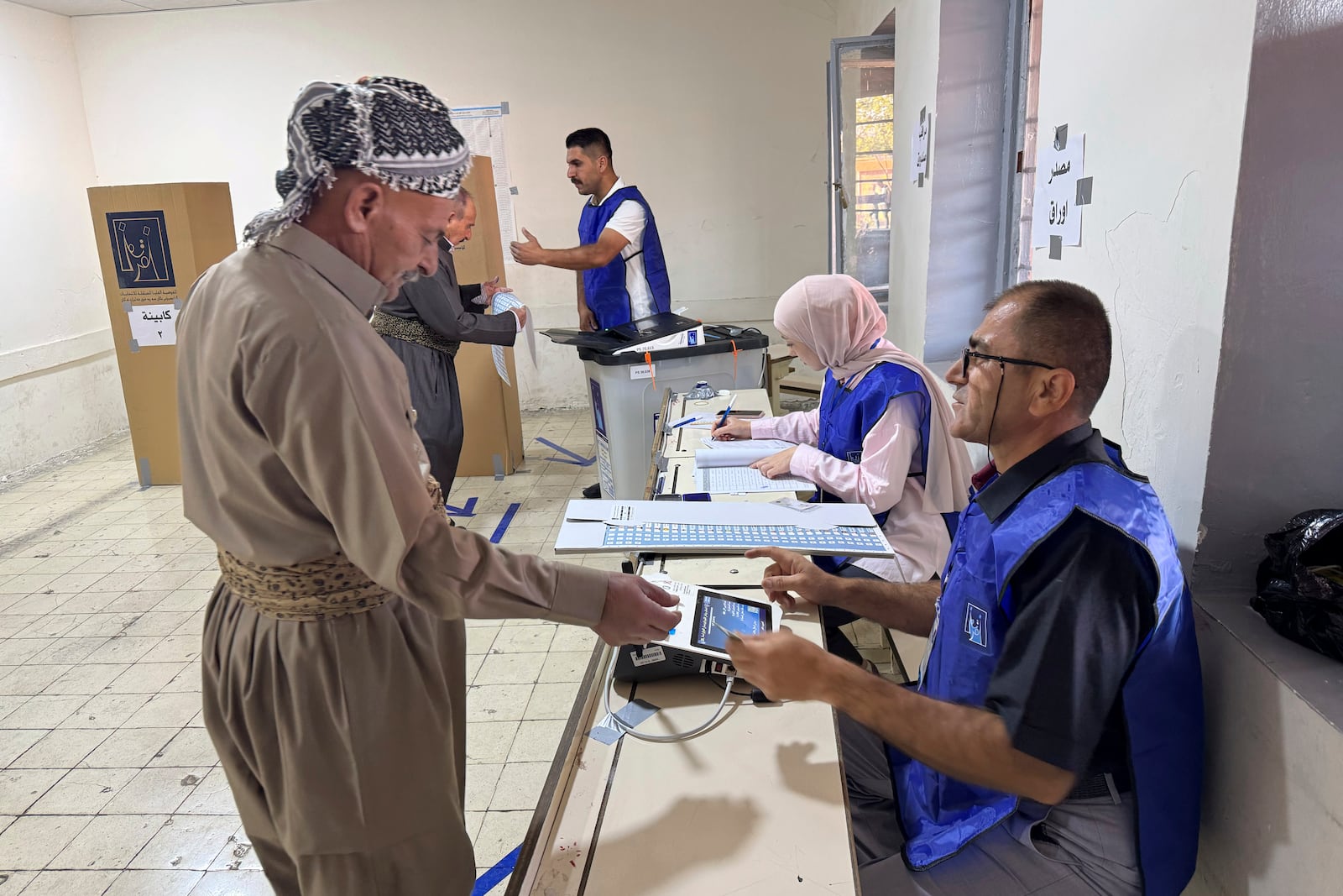 A man registers to vote during parliamentary elections of Iraq’s semi-autonomous northern Kurdish region, in Irbil, Sunday, Oct. 20, 2024. (AP Photo/Salar Salim)