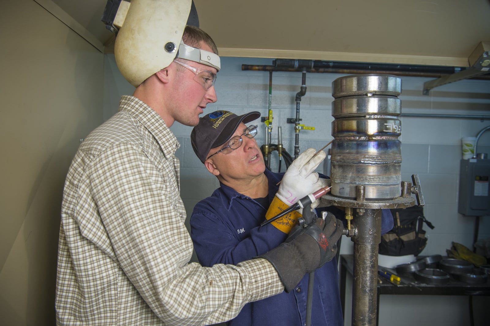 Tom Crawford, instructor at at The Hobart Institute of Welding Technology instructs Brett Schulte of Ottawa, Ohio, who has since graduated. Hobart graduates earn about $18 an hour upon graduation.