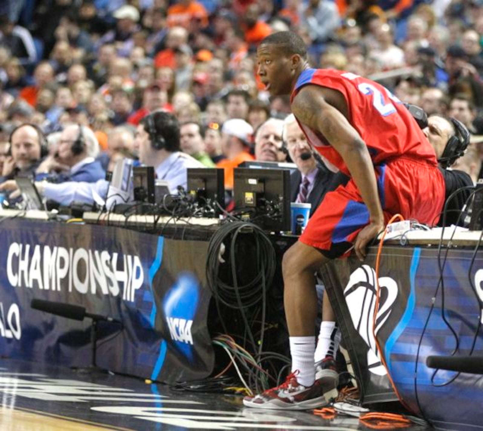 Dayton's Jordan Sibert falls onto press row in the second round of the NCAA tournament on Thursday, March 20, 2014, at the First Niagara Center in Buffalo, N.Y.