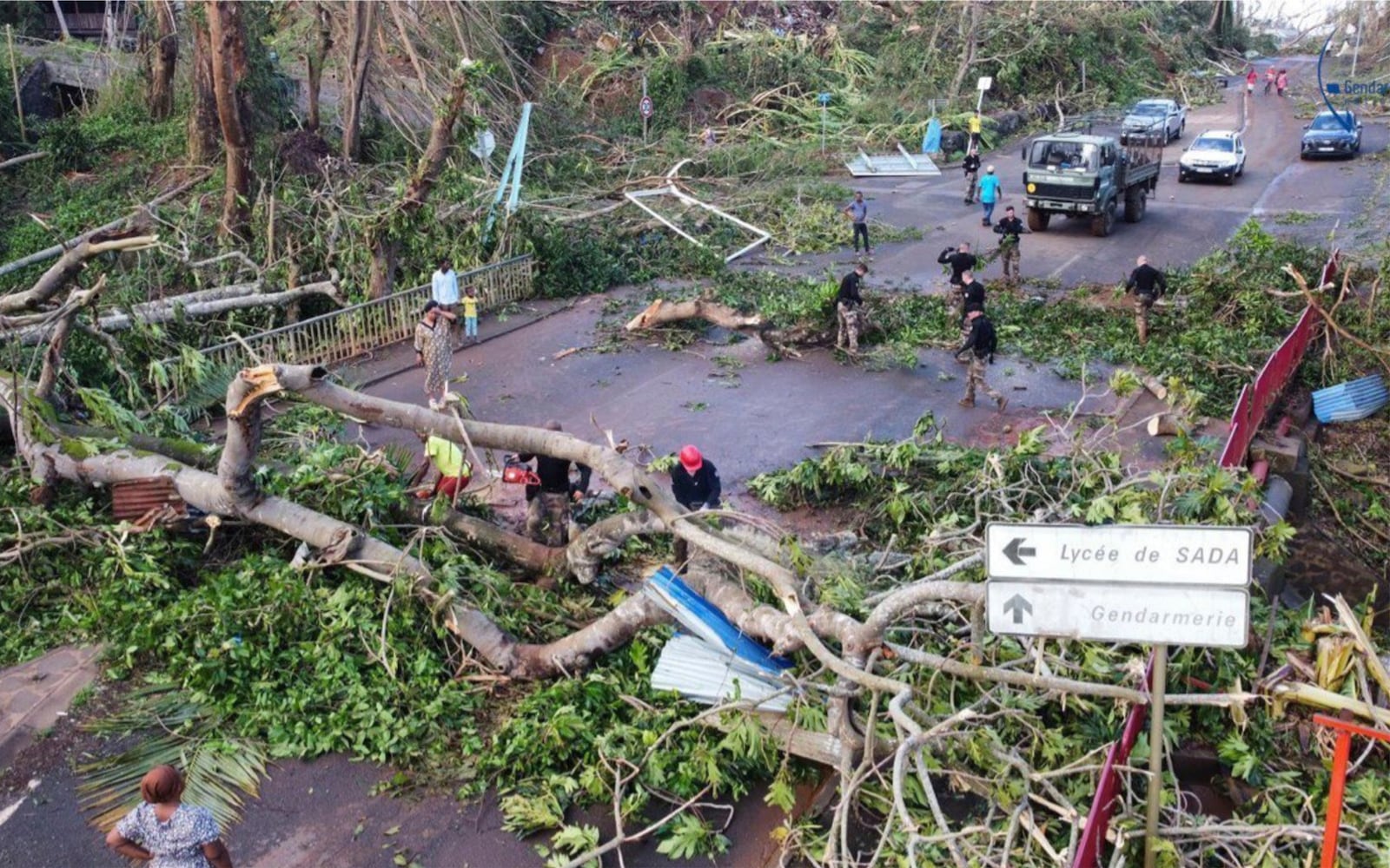 This undated photo provided Tuesday Dec. 17, 2024 by the French Interior Ministry shows gendarmes clearing a road in the French territory of Mayotte in the Indian Ocean, after the island was battered by its worst cyclone in nearly a century, (Ministere de l'Interieur/Gendarmerie Nationale via AP)