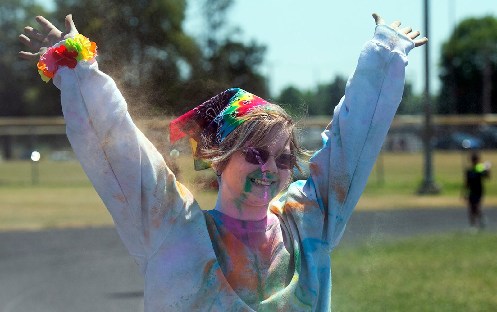 A color run participant, with a cloud of color trailing behind her, celebrates Colorfest on June 30 at Wright-Patterson Air Force Base. The party was the closing event for Wright-Patt’s Pride Month observance.  U.S. AIR FORCE PHOTO/R.J. ORIEZ