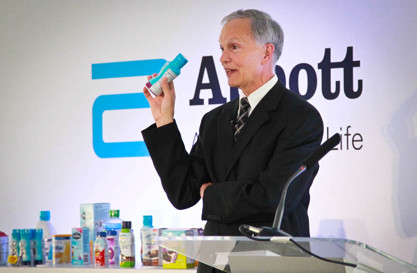 In this file photo, Abbott Executive Vice President John Landgraf holds one of the products the company will make at its facility in Tipp City at a plant opening ceremony. STAFF FILE PHOTO / JIM WITMER