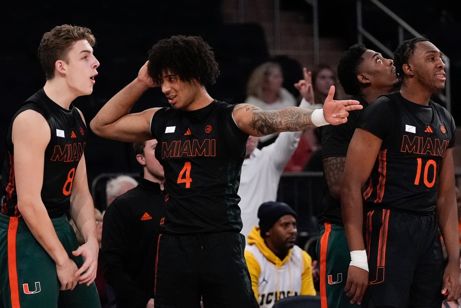 Miami forwards Xander Alarie (8) and Isaiah Johnson-Arigu (4) and guard Paul Djobet (10) react during the first half of an NCAA college basketball game against Tennessee, Tuesday, Dec. 10, 2024, in New York. (AP Photo/Julia Demaree Nikhinson)