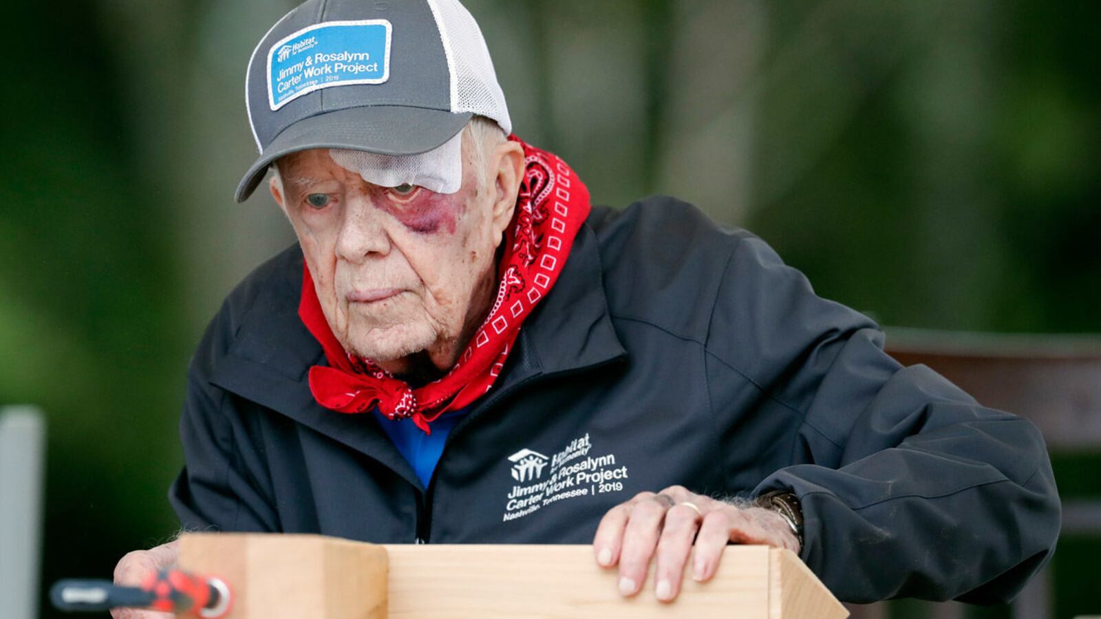 With a bandage above his left eye and a large, red welt below it, former President Jimmy Carter builds corbels at a Habitat for Humanity project Monday, Oct. 7, 2019, in Nashville, Tenn.