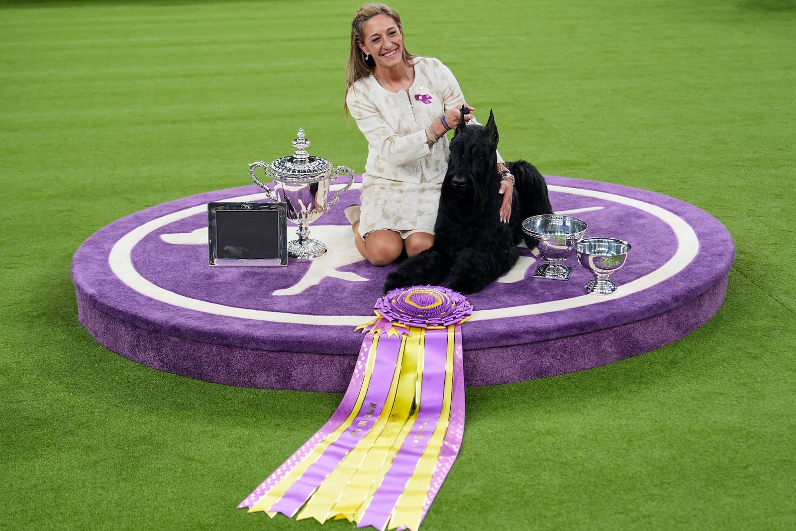 Katie Bernardin and Monty, a Giant Schnauzer, celebrate after winning best in show in the 149th Westminster Kennel Club Dog show, Tuesday, Feb. 11, 2025, in New York. (AP Photo/Julia Demaree Nikhinson)