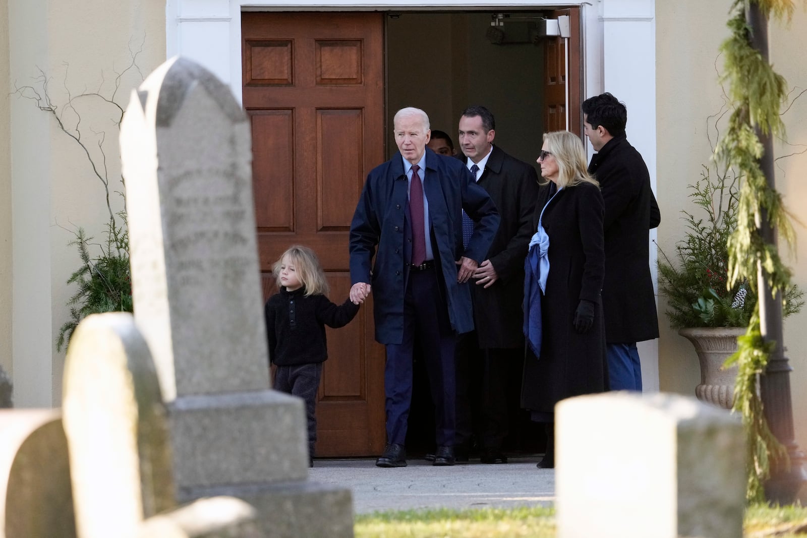 President Joe Biden, first lady Jill Biden and grandson Beau Biden step out of Brandywine Catholic Church in Wilmington, Del., on Wednesday, Dec. 18, 2024. Wednesday marks the 52nd anniversary of the car crash that killed Joe Biden's first wife Neilia Hunter Biden and 13-month-old daughter Naomi. (AP Photo/Ben Curtis)