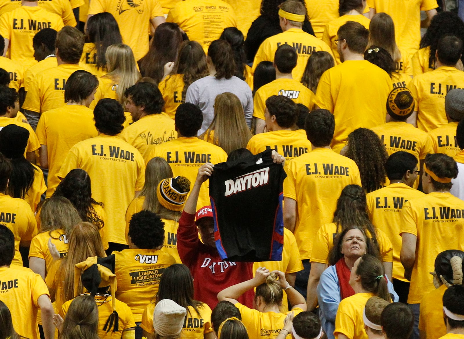 Two Dayton fans sit in a sea of Virginia Commonwealth fans on Saturday, Feb. 28, 2015, at the Siegel Center in Richmond, Va.