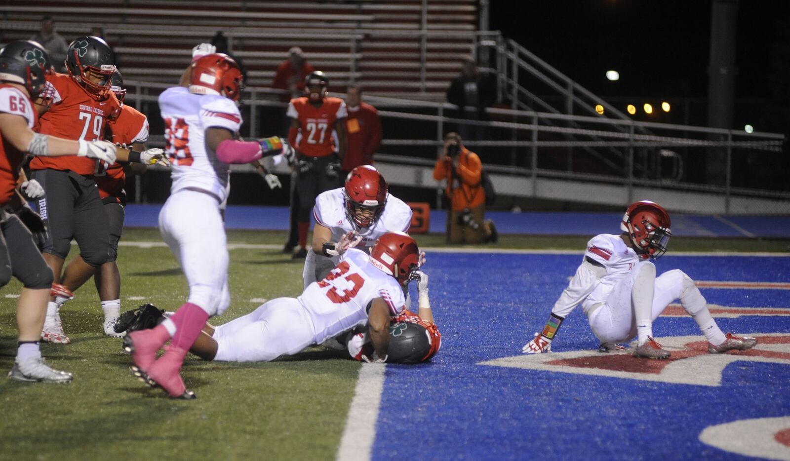 Trotwood’s Joshua Jordan (23) and Kennedy Coates (top) celebrate a near stop of TCC’s Jase Bowen at the goal line. Trotwood-Madison defeated Toledo Central Catholic 16-7 in a D-III high school football state semifinal at Piqua on Friday, Nov. 24, 2017. MARC PENDLETON / STAFF