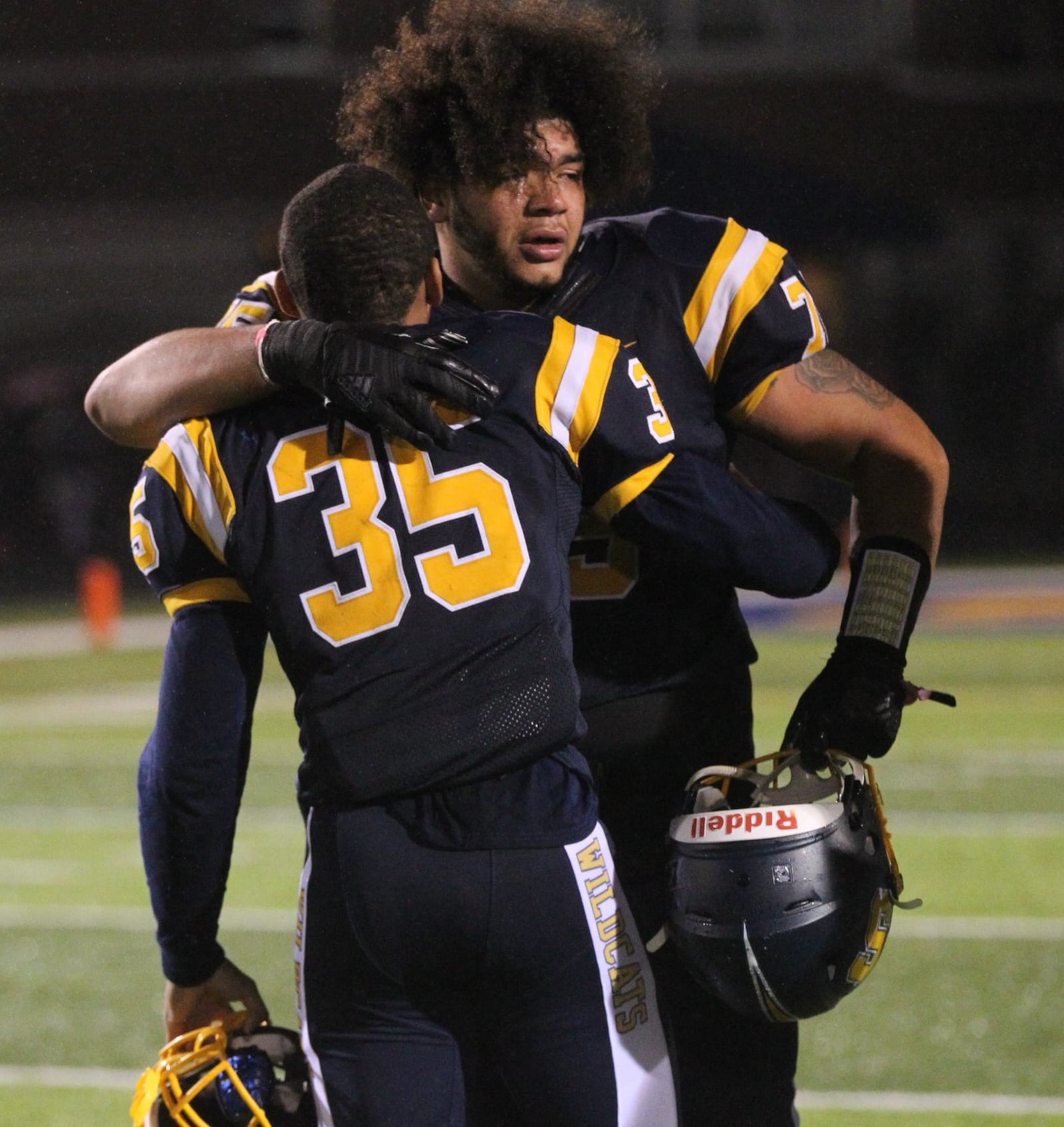 Springfield’s Isaiah Gibson and Jeff Tolliver hug after a victory against Wayne on Friday, Oct. 19, 2018, at Evans Stadium in Springfield. David Jablonski/Staff