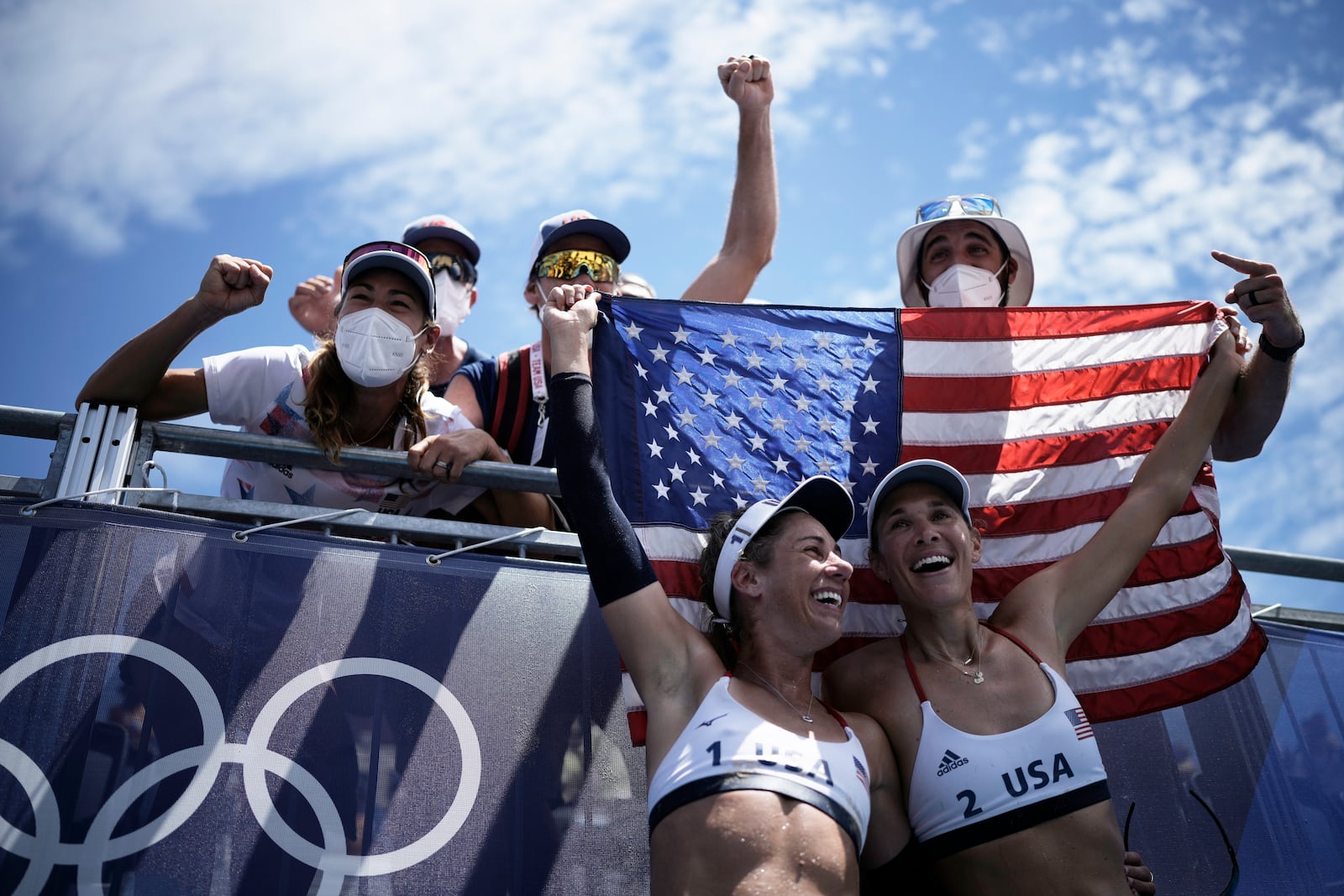 FILE - April Ross, bottom left, of the United States, and teammate Alix Klineman, bottom right, celebrate after winning a women's beach volleyball gold medal match against Australia at the 2020 Summer Olympics, Aug. 6, 2021, in Tokyo, Japan. (AP Photo/Felipe Dana, File)