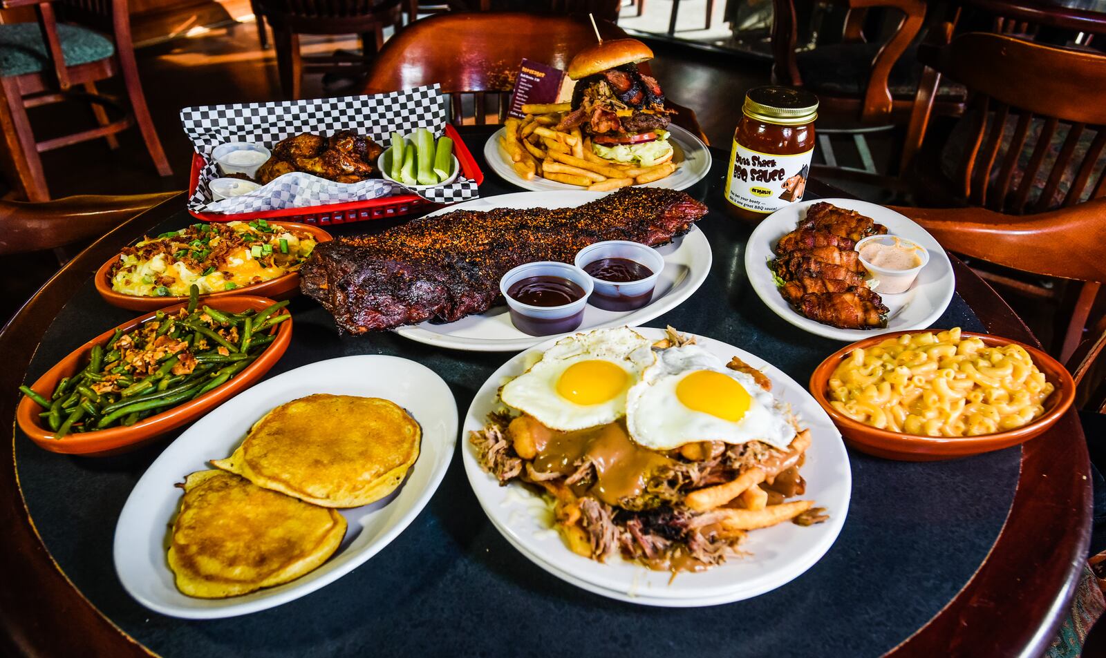 A sampling of some of the menu items at Butt Shack BBQ & Grill in Fairfield, including baby back ribs, All-American Burger, poutine, jumbo smoked wings and side items.