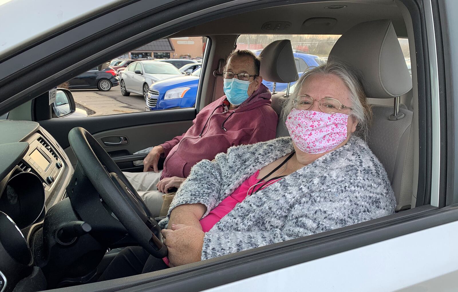 Debbie Tompkins of Kettering drove friend Gary Miller of Dayton to get a turkeys at a giveaway by With God’s Grace Mobile Food Pantry. CHRIS STEWART / STAFF