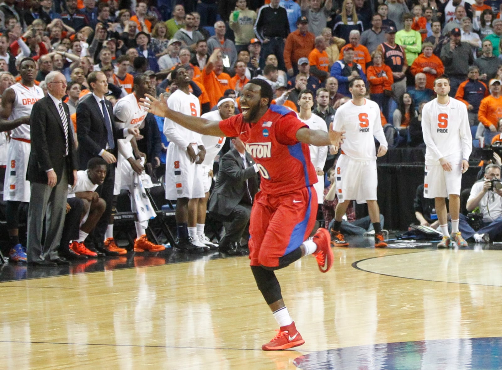 Dayton's Khari Price celebrates after Dayton beat Syracuse in the third round of the NCAA tournament on Saturday, March 22, 2014, at the First Niagara Center in Buffalo, N.Y. David Jablonski/Staff