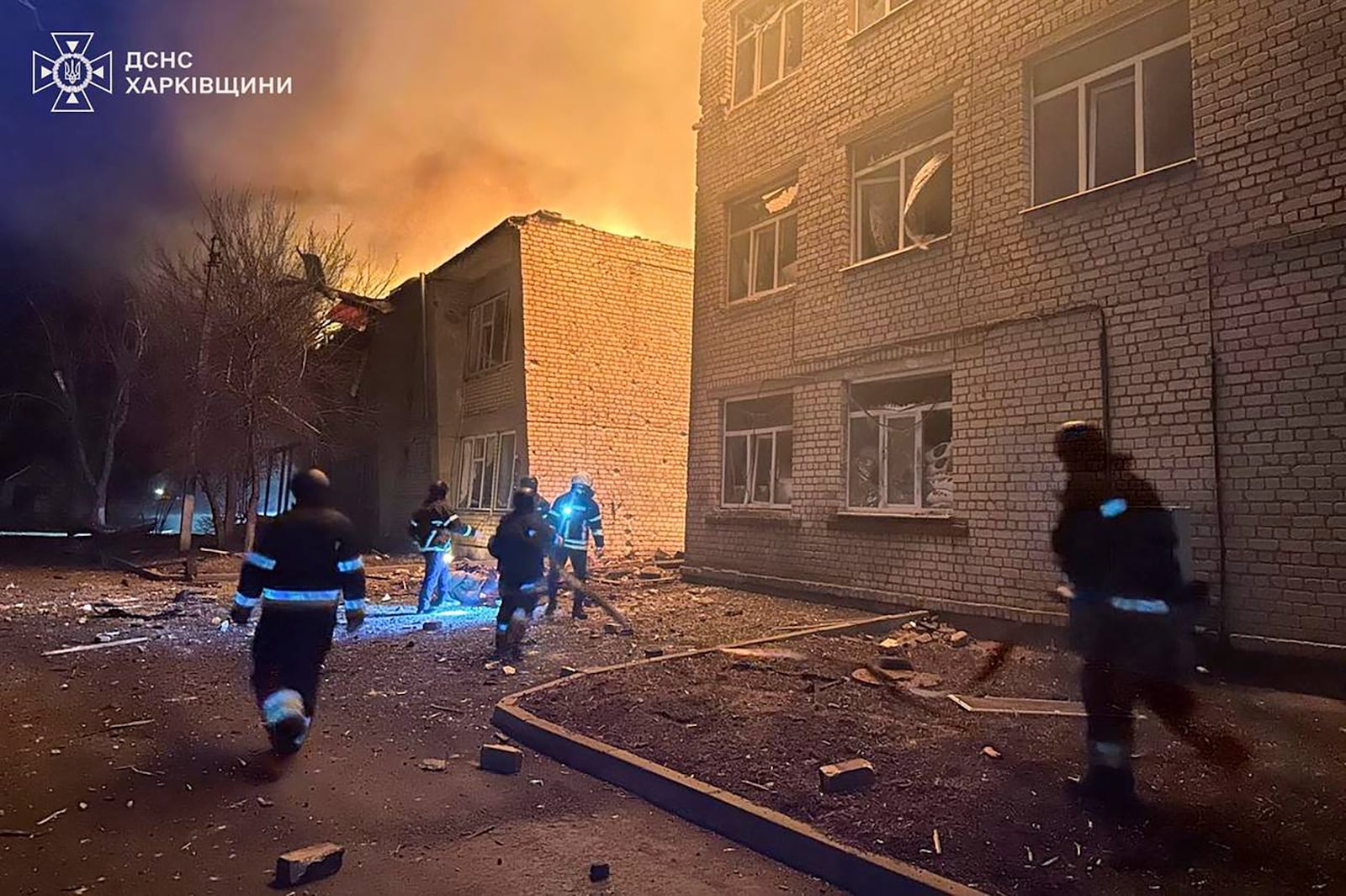 In this photo provided by the Ukrainian Emergency Service, firefighters put out the fire at a civilian hospital following a Russian drone attack in Zolochiv, Kharkiv region, Ukraine, Friday, March 14, 2025. (Ukrainian Emergency Service via AP)