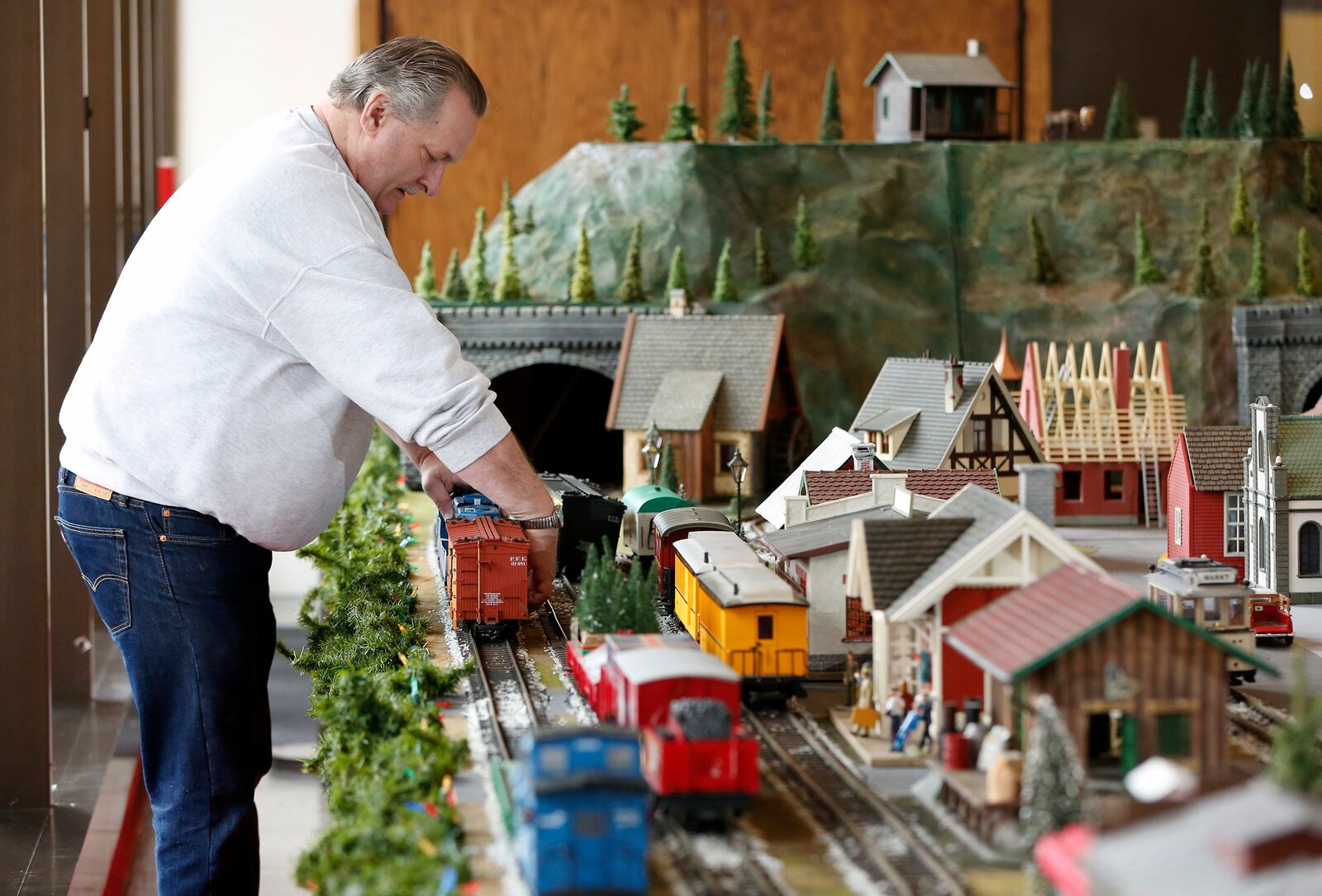 Chris Schultz, the owner of Schultz’s Hobbies, and a team of volunteers from the Miami Valley Garden Railway Society, maintain the Virginia Kettering holiday train display and assemble it in the Kettering Tower lobby each year. LISA POWELL / STAFF