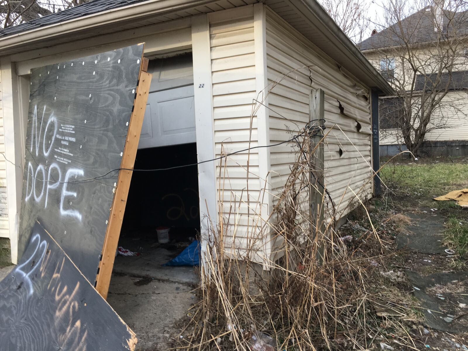 Boards are torn off the garage of the vacant house at 22 W. Hudson Ave. Dayton, where Krystal Garcia, 30, of Dayton was found shot to death Sept. 25, 2017 in back yard. The cause of death is homicide. STAFF Lynn Hulsey