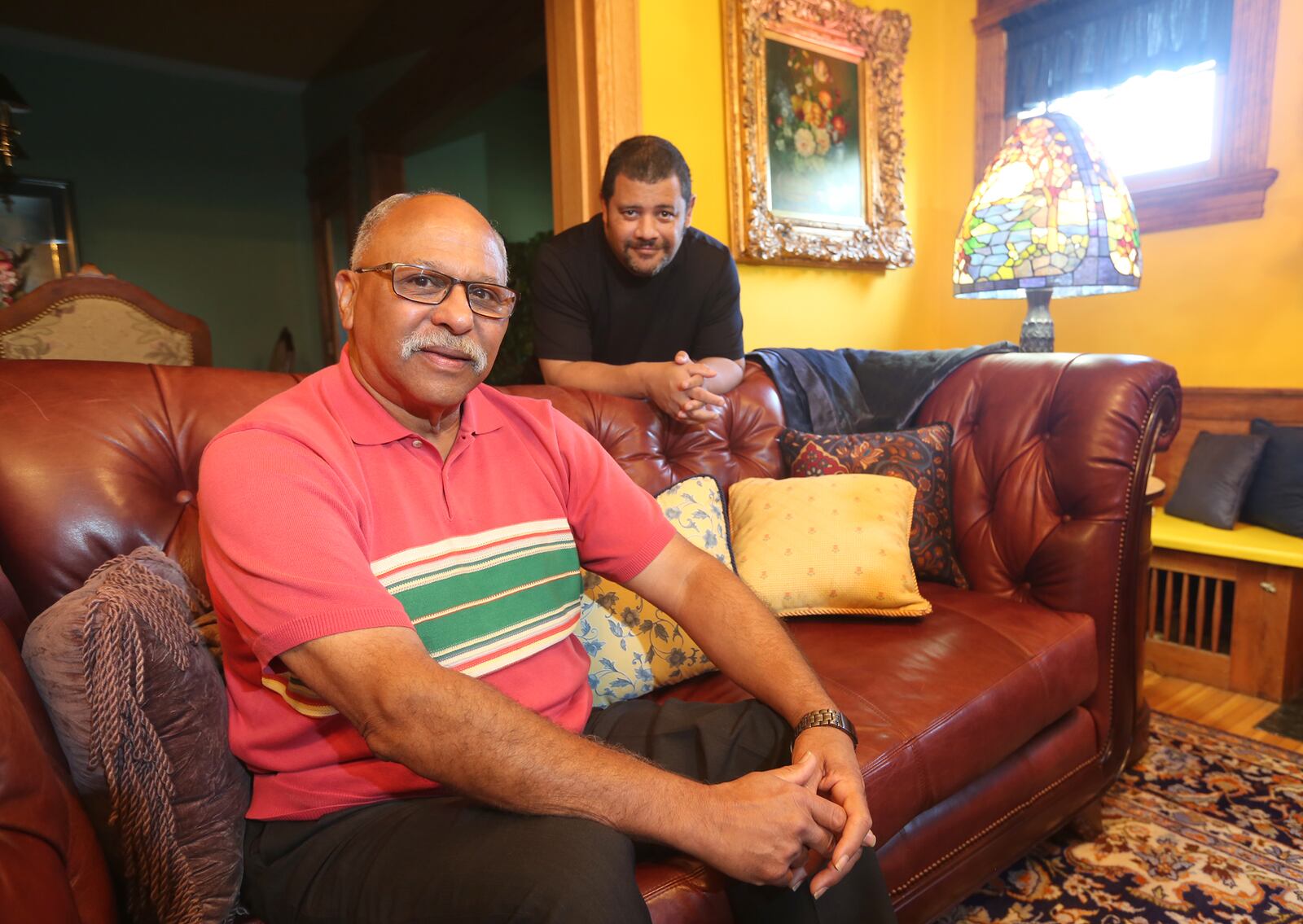 Fred Holley (seated) with his son, Frederick Leon Holley.  LISA POWELL / STAFF