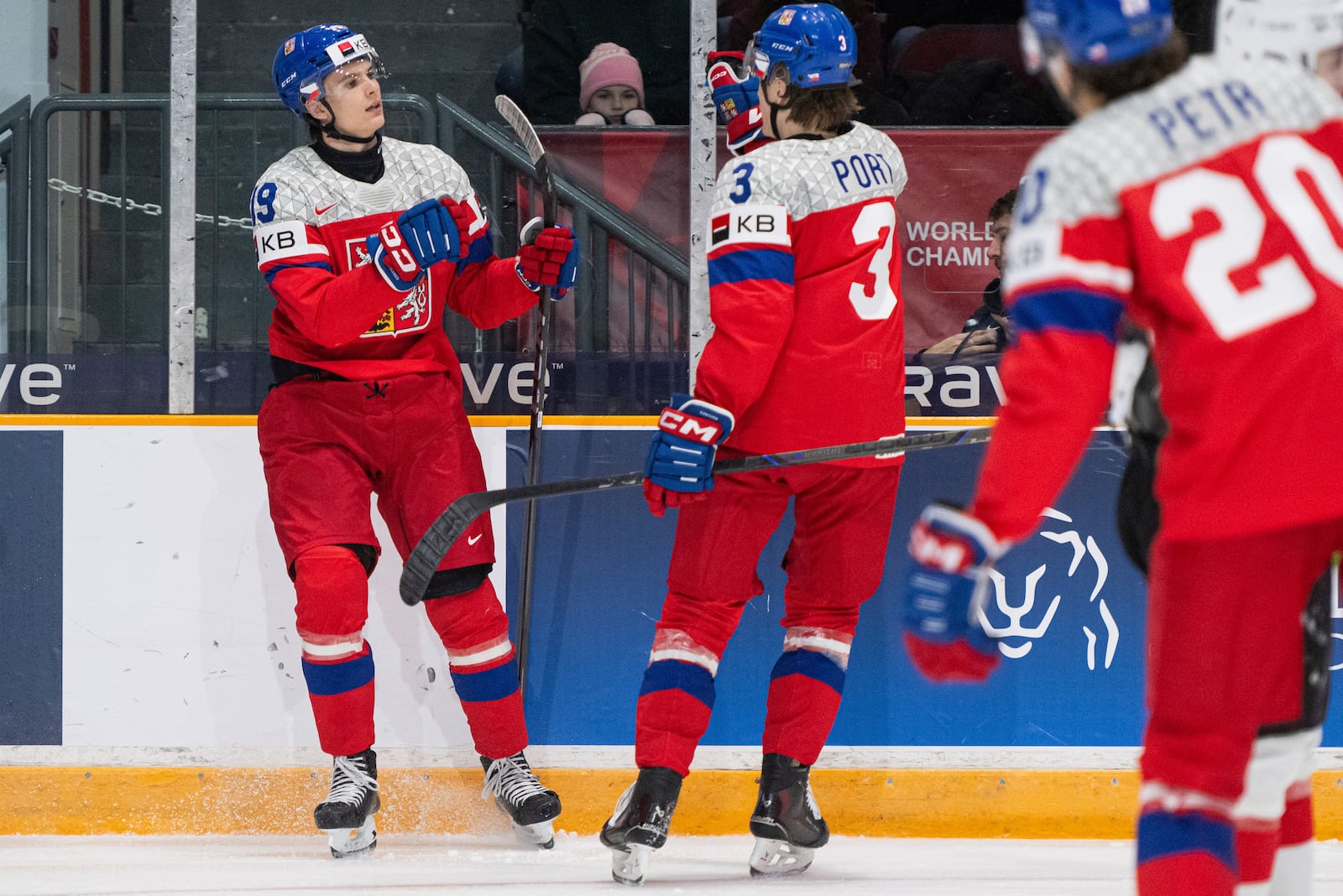 Czechia forward Ondrej Kos (19) celebrates his goal with teammate defenseman Vojtech Port (3) during second period action against Team Switzerland at the IIHF World Junior Hockey Championship preliminary round in Ottawa, Thursday, Dec. 26, 2024. (Spencer Colby/The Canadian Press via AP)