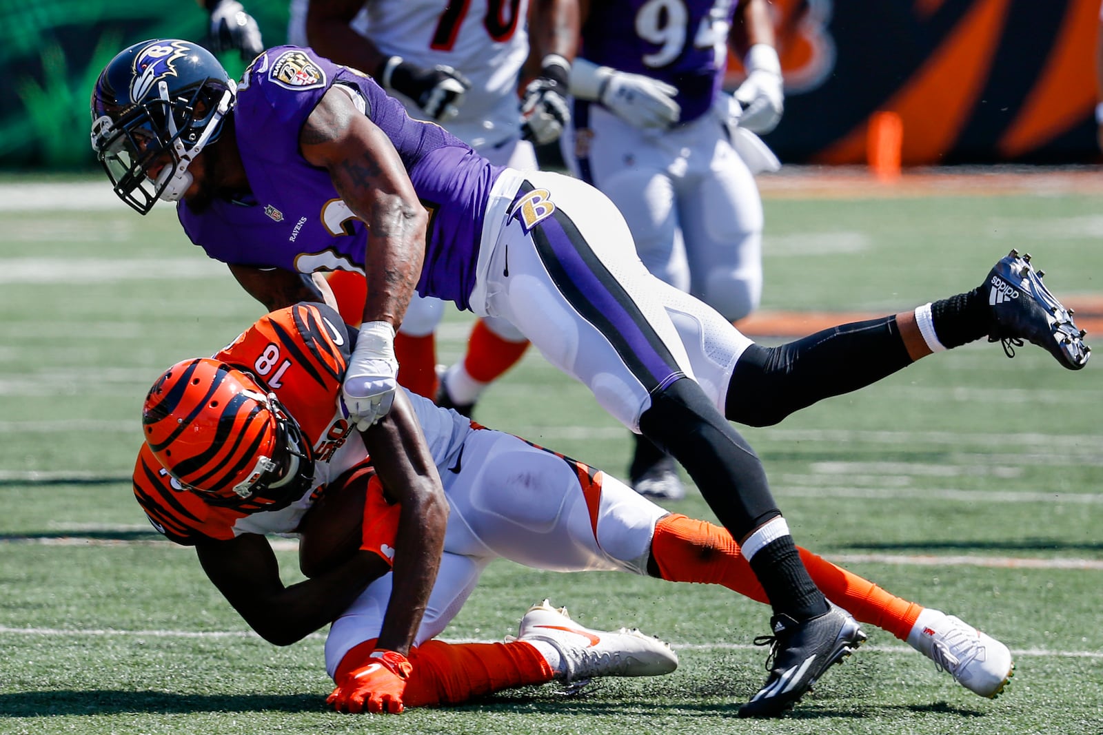 Baltimore Ravens cornerback Jimmy Smith (22) tackles Cincinnati Bengals wide receiver A.J. Green (18) in the first half of an NFL football game, Sunday, Sept. 10, 2017, in Cincinnati. (AP Photo/Frank Victores)