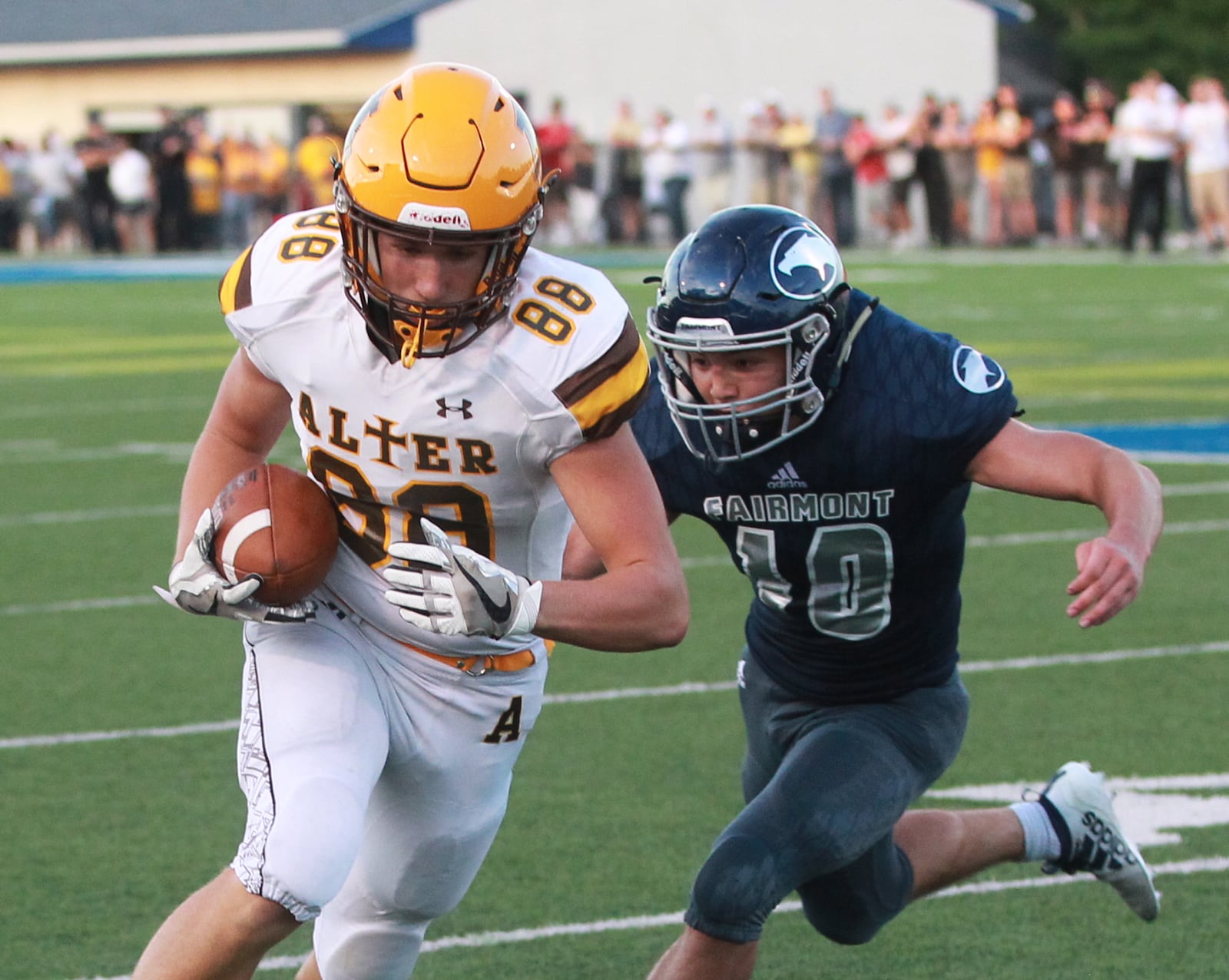 Joe Manfre of Alter (with ball) draws Fairmont defender Evan Overholser. Alter defeated host Fairmont 21-7 in a Week 1 high school football game on Thursday, Aug. 29, 2019. MARC PENDLETON / STAFF