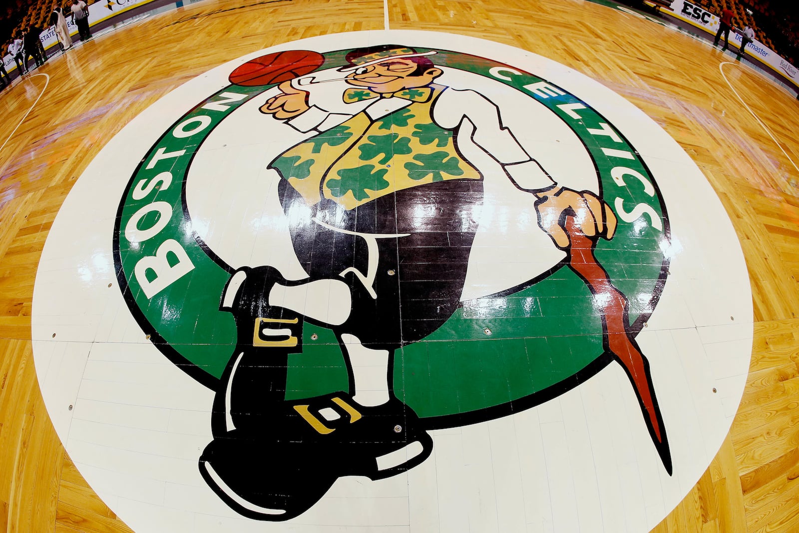 FILE - In this image taken with a fisheye lens, the Boston Celtics logo is seen at center court on the parquet floor before before taken up for a Boston Bruins NHL hockey game later in the day, Sunday, April 8, 2018, in Boston. (AP Photo/Winslow Townson, File)