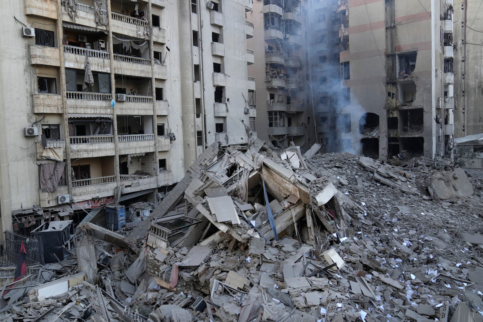 Smoke rises from a destroyed building that was hit by an Israeli airstrike on Dahiyeh, in the southern suburb of Beirut, Lebanon, Friday, Nov. 1, 2024. (AP Photo/Hussein Malla)