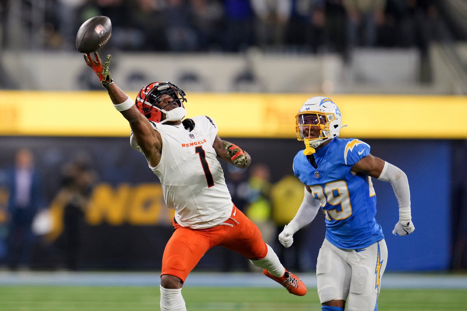 Cincinnati Bengals wide receiver Ja'Marr Chase (1) reaches but cannot make a catch in front of Los Angeles Chargers cornerback Tarheeb Still (29) during the second half of an NFL football game Sunday, Nov. 17, 2024, in Inglewood, Calif. (AP Photo/Eric Thayer)