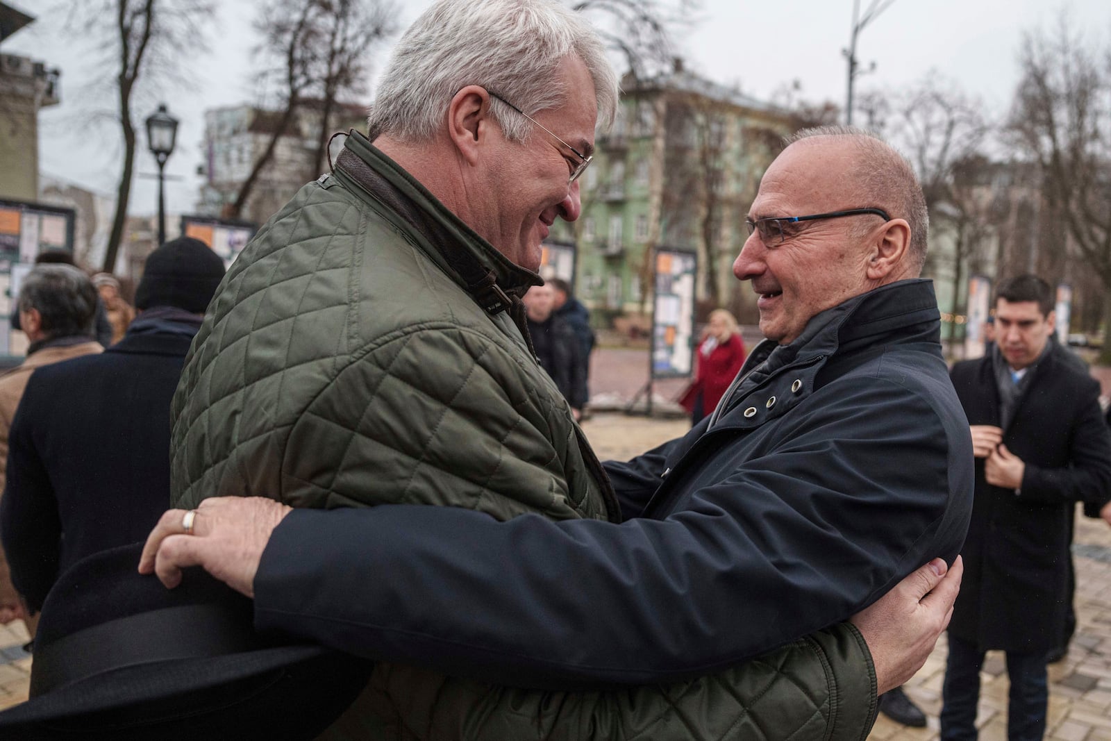 Ukraine's Foreign Minister Andriiy Sybiha hugs Croatia's Foreign Minister Gordan Grlic Radman before a flower ceremony at The Wall of Remembrance of the Fallen for Ukraine at St Michael's Square in Kyiv, Ukraine, Friday Jan. 17, 2025. (AP Photo/Evgeniy Maloletka)